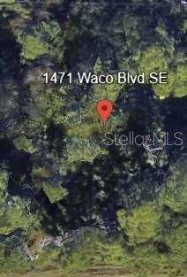Build your dream home in the heart of southeast Palm?Bay! Located at 1471 Waco Blvd SE, this vacant lot offers a fantastic opportunity in a thriving neighborhood. With easy access from paved roads, this parcel is ready for your vision—ideal for a custom residence or long-term investment. Just minutes from schools, shopping, dining, and major commuting routes, the location combines convenience with a peaceful setting. Easy build-out or hold for the future—don’t miss your chance to secure a valuable piece of land in the desirable Port?Malabar area.