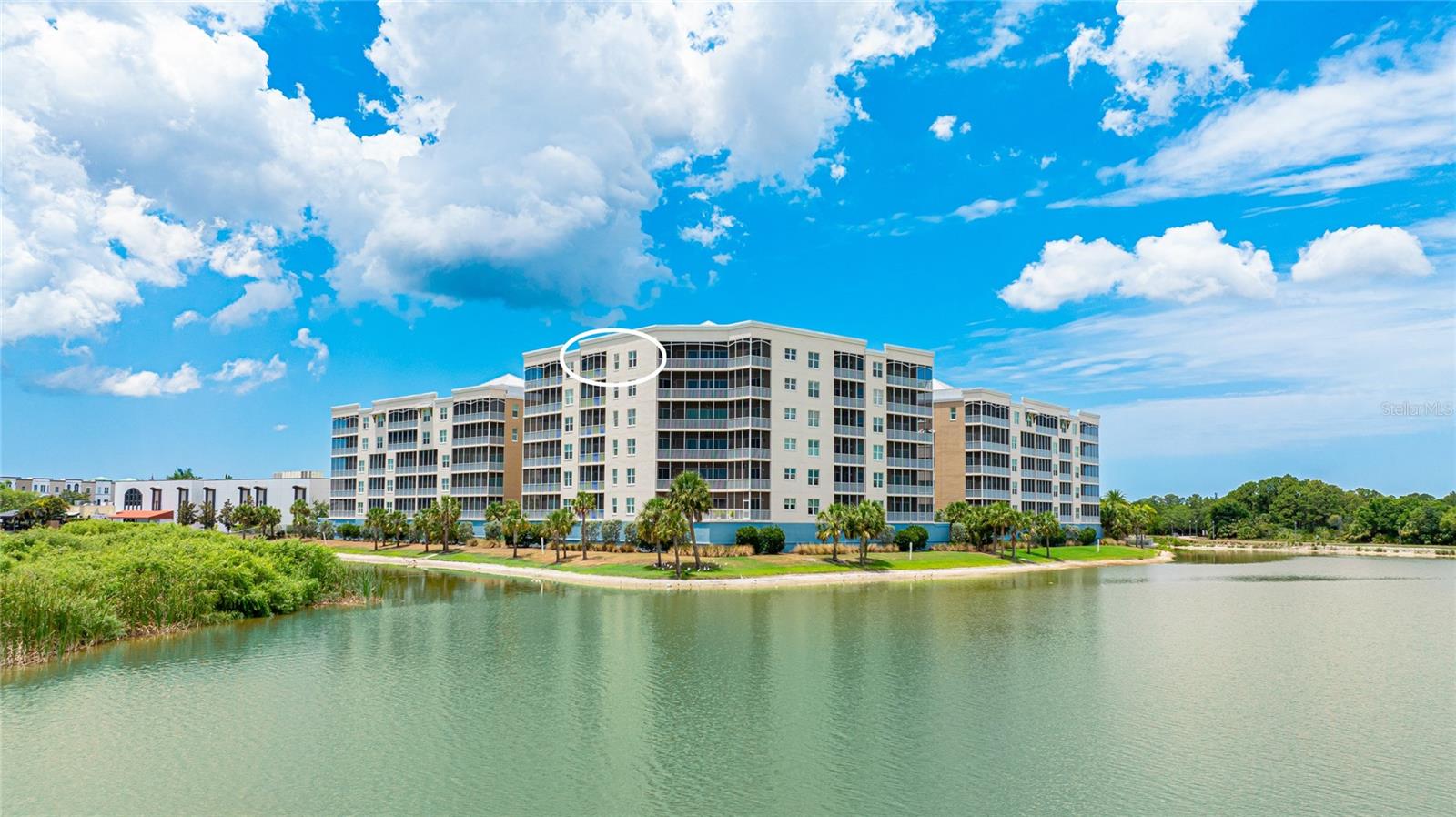 Very private and rarely available top-floor 2-bedroom plus den/office residence offering breathtaking 10+ mile panoramic views from the 7th floor in an exclusive gated waterfront community in the heart of downtown Lakewood Ranch.

Enter through the private gates and enjoy the convenience of covered parking beneath the building, a private storage locker, and elevator access directly to the top floor. Upon opening the front door, you are immediately welcomed by an exceptional open floor plan and high-quality finishes throughout.

The owner’s suite features awe-inspiring water and woods and golf and estuary views, creating a serene retreat to start each day. Both the owner’s suite and the family room provide access to a spacious private lanai, where you can relax and take in the abundant Southwest Florida wildlife overlooking Lake Uihlein and the Legacy Golf Course.

Recent upgrades include a $30,000 custom laundry renovation with added storage and a built-in wine cooler. Additional features include impact-resistant windows and sliders, as well as a built-in fire sprinkler system for peace of mind.

Community amenities are truly resort-style and include a heated lakeside pool, spa, fire pit, grilling stations, a well-equipped fitness center, and a beautiful clubhouse with catering kitchen and expansive outdoor entertaining areas. Kayak storage with lake access is also available.

Lakewood Ranch Main Street is just a few hundred feet away, offering a cinema, miniature golf, boutique shopping, restaurants, and year-round entertainment. Ideally located just minutes from UTC Mall, with easy access to downtown Sarasota and Bradenton, I-75, and a short drive to the stunning beaches of Lido Key and Anna Maria Island.

Be sure to view the attached live video tour and 3D walkthrough for a complete experience of this exceptional home.