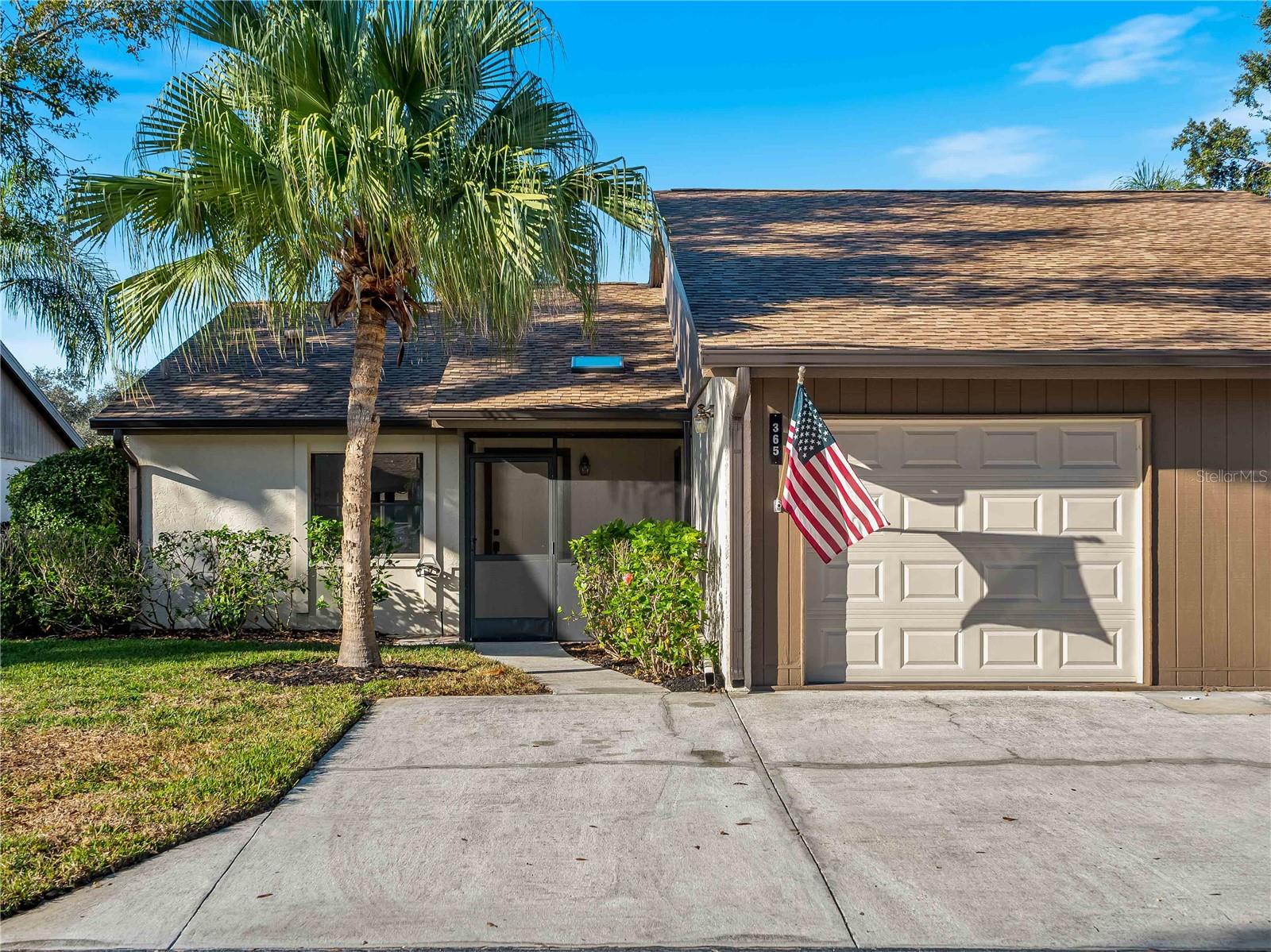 Virtually Staged. Nestled in the quiet, pet friendly community of Village Oaks features this Immaculate updated 2-bedroom, 2 bathroom Condo/Villa that offers a move-in-ready retreat.  This fully updated unit features a new hot water heater installed in January 2026 and boasts a freshly repainted interior throughout.  The modernized kitchen offers a pass-through to the dining area. Updated Master Bath with dual sinks, and walk in shower. Enjoy the look of luxury vinyl that flows seamlessly through every room. The open-concept living room boasts of high ceilings, while an enclosed Florida room (lanai) provides a private space to enjoy the lush surroundings. The villa features a convenient in unit laundry area with a washer and dryer tucked into a dedicated laundry closet.Enjoy the convenience of a private one car garage with remote access, plus two dedicated exterior parking spots right outside your villa. Community pool overlooking lake along with tennis/pickleball court for outdoor activities. Ideally situated between I-75 and downtown Sarasota, offering quick access to the University Town Center Mall (UTC), local dining and world-class beaches.