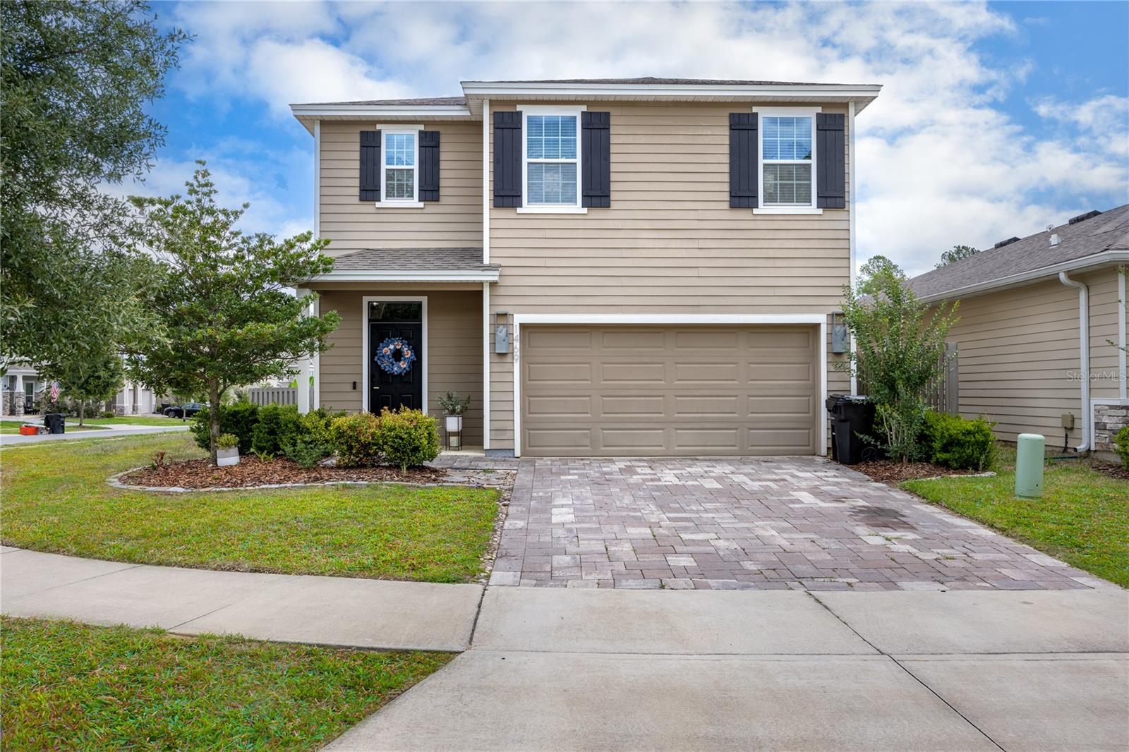 Discover the perfect blend of style, space, and functionality in this beautifully upgraded 5-bedroom, 3-bathroom home located on a desirable corner lot in Arbor Greens. Built in 2021, this two-story home offers all the benefits of newer construction with thoughtful custom touches throughout. Step inside through the welcoming entryway featuring stunning moody accent walls that set the tone for the home’s modern design. The open-concept layout seamlessly connects the kitchen, dining, and living spaces, creating the ideal setup for entertaining and everyday living. The chef-inspired kitchen is truly the heart of the home, complete with a large island, coffee bar, modern appliances, and a walk-in pantry with custom built-ins for exceptional storage and organization. A first-floor bedroom and full bathroom provide the perfect flexible space for guests, a home office, or multi-generational living. Upstairs, you’ll find an additional open living area offering even more room to relax or gather. The spacious primary suite easily accommodates a sitting area and features a large walk-in closet and an en-suite bathroom with dual vanities, a walk-in shower, and linen storage. Three additional upstairs bedrooms share a well-appointed full bathroom, while the upstairs laundry room includes custom built-in storage for added convenience. Step outside to enjoy the covered back porch overlooking the backyard perfect for pets, play, or outdoor entertaining. With upgraded features, versatile living spaces, and a prime location in Arbor Greens, this move-in ready home is one you won’t want to miss. Ideally located in Jonesville just minutes from Tioga Town Center, top-rated Alachua County schools, and with easy access to University of Florida, UF Health Shands Hospital, and HCA Florida North Florida Hospital. The personal touches in this home are elegant and timeless and make this home a standout, don’t miss out!