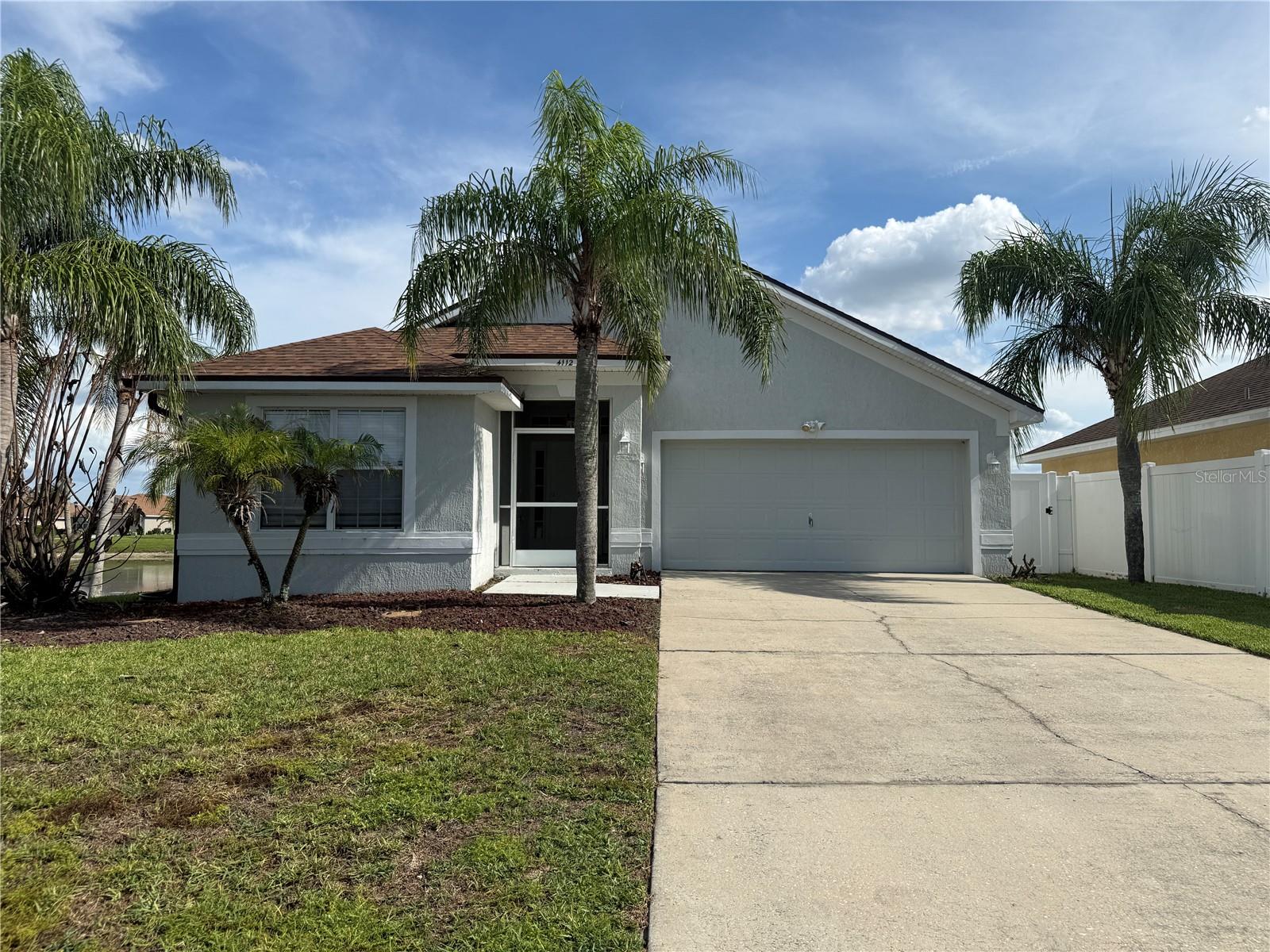 Embrace the opportunity to make this expansive 3-bedroom, 2-bathroom abode your new home. This residence is ready for immediate occupancy and boasts a prime location within the sought-after Island Lakes community. Residents here can easily access the Chain of Lakes via the nearby Lake Conine boat ramp perfect for fishing, water sports, or leisurely lake outings. Inside, discover an inviting, open layout ideal for entertaining or simply relishing in comfortable living, enhanced by lofty vaulted ceilings. The generous kitchen offers ample space, a cozy eating nook, and a practical cooking island. The home further encompasses an inviting master suite, a well-planned split bedroom design with two guest bedrooms. Step into the backyard and experience tranquility within the screened lanai and enclosed yard. This attractive residence is primed, and families imbue it with their personal touch. Ready for viewing
