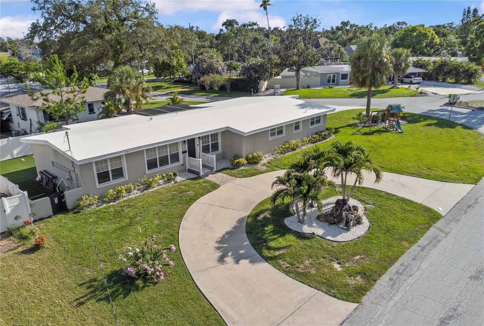BEST VALUE IN BELLEAIR *** Welcome to this NEWELY REMODELED and beautifully updated 3-bedroom, 2-bathroom home with a dedicated office and spacious 2-car garage, located in one of the most sought-after neighborhoods in Pinellas, Belleair! Sitting proudly on a large corner lot of almost a quarter acre, the home greets you with a wide circular driveway that sets the tone for the comfort and ease that follows. The home has plenty of space for a POOL in the back yard which has been quoted out and info can be provided if desired. 

Step inside and you’re welcomed by bright, open living spaces filled with natural light and modern design elements. Luxury vinyl plank flooring guides you from room to room as the living area flows effortlessly into the heart of the home, a stunning gourmet kitchen designed for both everyday living and memorable gatherings. Quartz countertops, a classic subway tile backsplash, sleek stainless appliances, and a stainless steel vent hood give this space a clean and timeless feel.

The primary suite offers a sense of calm at the end of the day with its oversized walk-in closet and beautifully remodeled bathroom featuring a floor-to-ceiling tiled walk-in shower with frameless barn-style glass doors. Two additional bedrooms and a separate office provide room to grow, create, and settle in comfortably.

Step outside and discover a backyard made for easy living. The vinyl-fenced yard wraps around a tranquil rock waterfall fountain, a screened porch, and freshly graded, maintenance-free turf that keeps weekends free for barbecues, family time, or simply unwinding in the sunshine.

Thoughtfully updated interior in 2026 and additional notable updates: new A/C system and ductwork installed in 2021, a new roof, fascia, and soffits - 2017, new windows, top of the line electrical panel and new main water line plumbing, redesigned living areas, refreshed lighting, remodeled bathrooms, new appliances, and turfed backyard. This home has never flooded and stands on its own elevated lot and has had no drainage concerns, adding another layer of reassurance.

Set on a quiet street in a non-flood, non-evacuation zone, this home places you moments from the Belleair Country Club and Pelican Golf Club, with the world-famous Clearwater beaches just a short drive away. This is a place where everyday living feels a little more special.