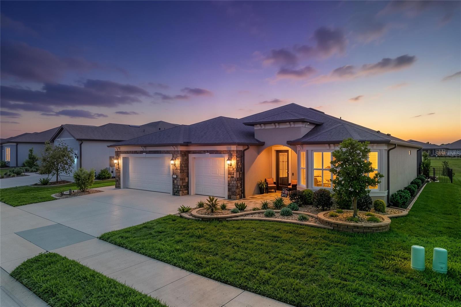 Experience luxury Florida living in this beautifully upgraded Stardom model featuring 2 bedrooms, 2.5 bathrooms, and a versatile flex room with elegant French doors. From the moment you arrive, you’ll notice the upgraded stone elevation, paver entrance, custom landscaping, and stunning glass inset front door that create exceptional curb appeal.

Inside, the home is loaded with designer upgrades including crown molding throughout, wainscoting accents, custom lighting, additional recessed lighting, plantation shutters, and a dramatic double tray ceiling in the living room. The gourmet kitchen showcases gorgeous quartz countertops, upgraded 42” cabinetry, and an open layout perfect for entertaining.

Step outside to your private backyard oasis featuring a heated saltwater pool and spa enclosed within a spacious birdcage enclosure. The pool is heated by a buried propane tank that also includes hookups for a grill and generator connections for added convenience and peace of mind. Enjoy the privacy of having no direct rear neighbors along with a fenced backyard ideal for relaxing or entertaining guests.

The spacious primary suite offers a luxurious tiled zero-entry walk-in shower, while the second bathroom also features an upgraded tiled shower. Additional highlights include a utility sink in the laundry room and an epoxy-coated garage floor for a clean, finished look.

This exceptional home combines luxury, comfort, and thoughtful upgrades both inside and out. Schedule your private showing today!
