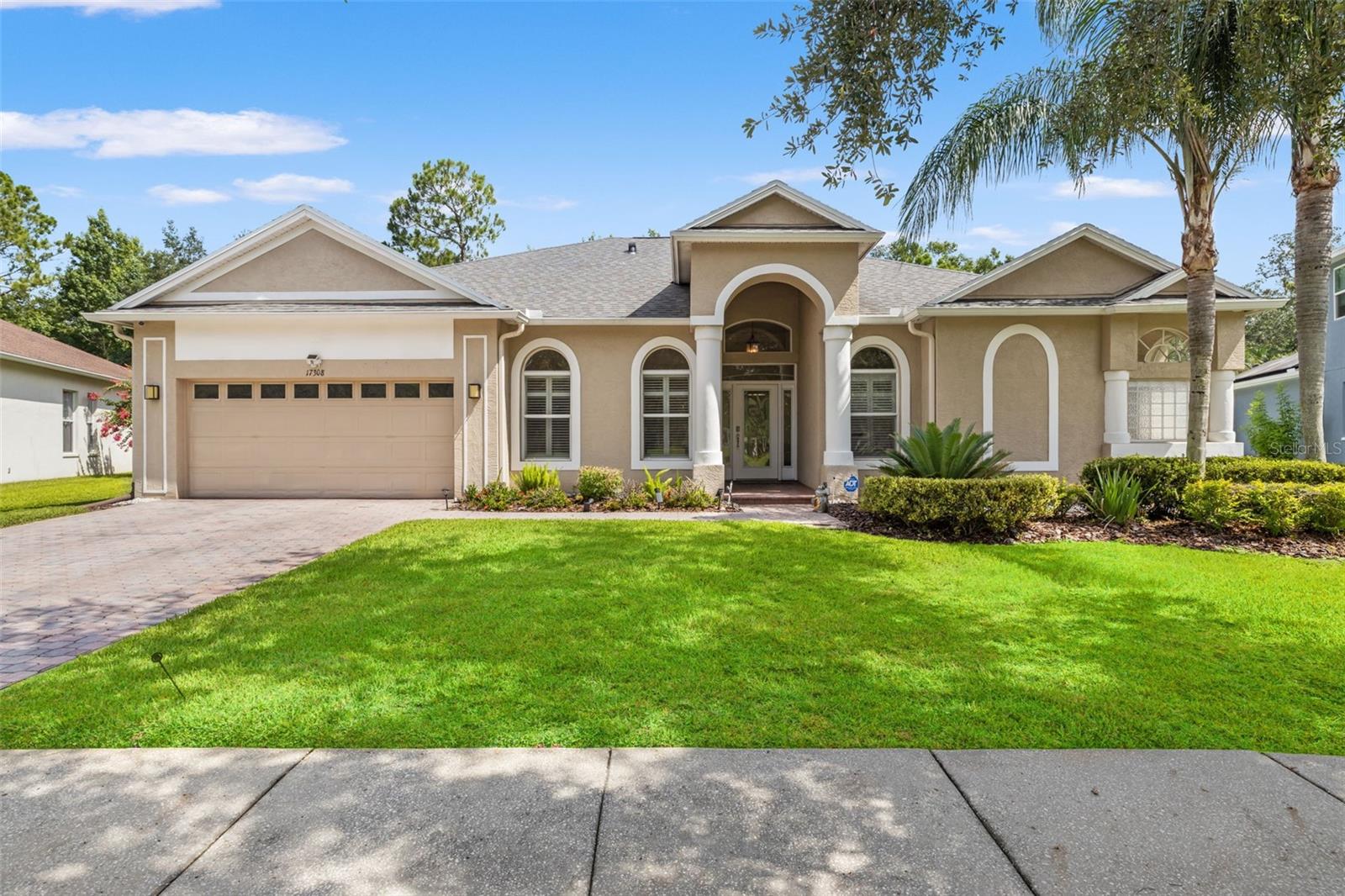 Welcome to the gated village of Ashington Estates in Tampa Palms, where modern design, energy efficiency, and exceptional updates come together in one impressive home. Powered by a whole-house solar system and thoughtfully remodeled throughout, this move-in ready residence offers 4 bedrooms, 3 full bathrooms, a dedicated office, and a 2-car garage.

From the moment you arrive, you'll appreciate the care and investment that has gone into this home. Major improvements include a newer roof, solar panel system, A/C, appliances, washer and dryer, landscaping, paver patio, fencing, interior paint, lighting, ceiling fans, plantation shutters, and beautiful travertine flooring throughout much of the home.

At the heart of the home is a stunning chef's kitchen designed for both everyday living and entertaining. Features include quartz countertops, white cabinetry accented by glass-front display cabinets, a large center island with additional espresso cabinetry and seating, reverse osmosis water system, built-in LG refrigerator, newer GE stainless steel appliances, contemporary glass tile backsplash, recipe desk area, oversized pantry, and a heavy-gauge stainless steel undermount sink. The kitchen opens seamlessly to the spacious family room, where sliding glass doors lead to the screened lanai and extended paver patio.

The owner's retreat is a private sanctuary featuring two walk-in closets, a built-in credenza, and a beautifully remodeled bathroom with custom espresso cabinetry, upgraded lighting, frameless glass shower, and designer finishes. Secondary bathrooms have also been updated with elegant stone accents, updated cabinetry, and modern fixtures.

Step outside to enjoy the fenced backyard overlooking tranquil conservation views, providing both privacy and a peaceful natural setting. Additional upgrades include a water softener, gutters, and Silhouette blinds.

Adding to the appeal, there are no front-yard neighbors. Instead, this home enjoys a picturesque setting overlooking a sprawling park and charming gazebo on a quiet side street.

Residents enjoy exclusive access to Club Tampa Palms, a multi-million-dollar recreation center featuring a state-of-the-art fitness facility, three swimming pools including a heated pool with waterslide, heated spa, tennis courts, basketball courts, playgrounds, and year-round activities. Conveniently located near top-rated schools, Tampa Premium Outlets, Wiregrass Mall, USF, major hospitals, I-75, and I-275, this home offers the perfect combination of luxury, convenience, and lifestyle.

A rare opportunity to own a beautifully updated, energy-efficient home in one of New Tampa's most sought-after communities.