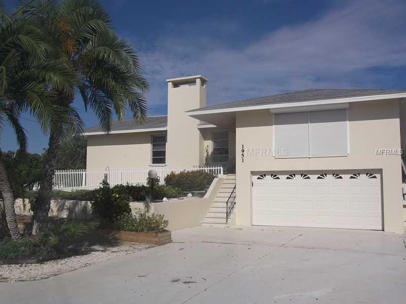 Fantastic Englewood waterfront home has no bridges to Lemon Bay and the Gulf of Mexico. This 3 bedroom/3 bath home offers magnificent sunsets down the waterway from the pool as well as inside activity areas. Sliding doors lead to the elevated pool deck enabling you to enjoy your outdoor living and water views. The dock has water and electric, is 60' long and includes a 20' boat lift for your fishing or water sport activities. The kitchen has crisp bright cabinets and solid surface counter tops, breakfast bar and wet bar, and views of the gas fireplace across the tiled family room. The partially fenced home is elevated and offers a downstairs to the two car garage and additional space that could easily be used as a workshop or for your hobbies. Roll down window and other hurricane protection is provided for the living spaces. This is definitely waterfront living at its best! You have finally found that perfect home for you and your boat. One year warranty core coverage plan for home and pool. A current elevation certificate is available showing base flood plain at 12.0 and the first habitable floor of home at 13.5. Flood insurance is estimated to be $1200 to $1800 per year under the new guidelines.