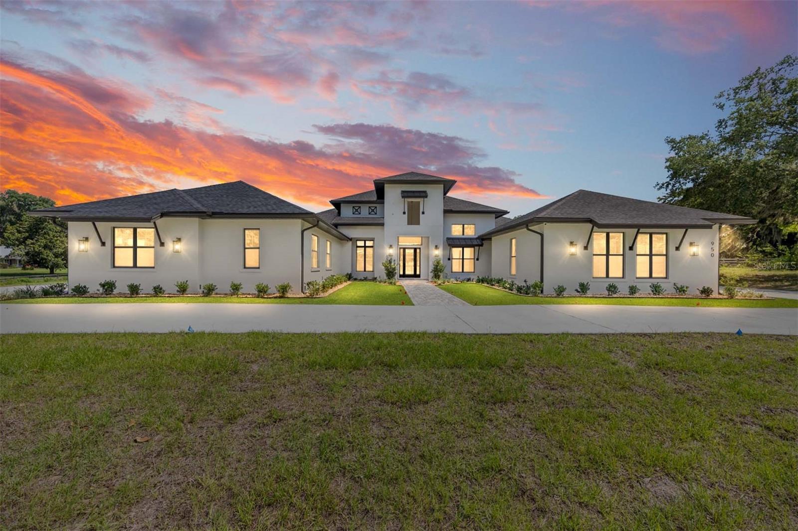 Why wait to build when your dream home is ready now? This brand-new Arthur Rutenberg masterpiece offers 4,251 square feet of thoughtfully designed living space with 4 bedrooms, 4 bathrooms, a bonus room, and a private den—all situated on 4.99 acres with no HOA, providing endless possibilities for a mini farm, recreational space, or simply enjoying the privacy of country living. Conveniently located just minutes from downtown Ocala and the Florida Horse Park, this property offers the perfect blend of luxury and location.

Step through the foyer into the stunning great room, where a gas fireplace serves as the centerpiece and 10-foot glass sliders seamlessly connect the indoor living space to the outdoor oasis. The chef’s kitchen is designed to impress, featuring an oversized island, gas range, separate convection oven, bar area with wine refrigerator and wine racks, plus a hidden oversized pantry complete with an additional refrigerator. The outdoor living area is equally impressive, with a finished summer kitchen overlooking the resort-style pool.

The luxurious primary suite is a private retreat, offering his-and-hers walk-in closets, a spa-inspired bath with double walk-in showers, and an adjoining flex room perfect for a home gym, nursery, or private office. The split-bedroom floor plan provides exceptional privacy, with three additional bedrooms located on the opposite side of the home, each featuring its own ensuite bath.

Additional features include a spacious utility/laundry room, bonus room, and a unique three-car garage configuration with two bays on one side of the home and a separate single-car garage on the other. The expansive pool area offers ample covered space for dining and entertaining, while privacy walls create a secluded backyard retreat.

For added peace of mind and efficiency, the home is equipped with two tankless water heaters and a whole-house generator.

This one-of-a-kind luxury estate is move-in ready and waiting for its new owner. Don't miss the opportunity to own a truly exceptional property—schedule your private showing today.