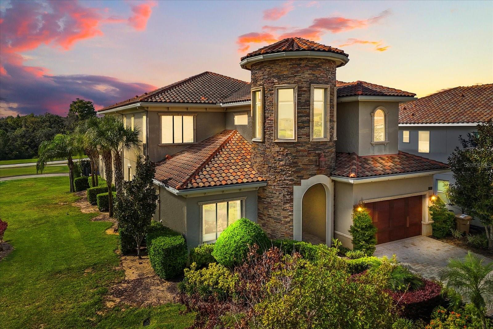 ** HUGE PRICE REDUCTION!!** PRICED TO SELL** This is a one of a kind, Architectural Masterpiece, custom built by one of the original luxury builders in Reunion Resort’s most coveted location in Central Florida.  This exquisite property is positioned on a corner lot along the 12th tee of the iconic Jack Nicklaus Signature Golf Course. As you walk through the grand 10-foot wrought-iron double doors, a world of sophistication unfolds. Every detail has been meticulously curated—from the bespoke millwork to the thoughtfully designed floor plan that effortlessly blends form and function. The main level features a richly appointed executive office with custom built-ins and an expansive owner’s suite, complete with private access to the outdoor oasis. The open-concept living area includes a chef’s kitchen with high-end appliances, a gracious dining space, and a stylish great room, all opening seamlessly to the outdoor entertaining terrace. The outdoor living experience rivals that of a five-star resort. Anchored by an oversized pool and elevated spa, this space boasts a double-sided gas fireplace, fully equipped kitchen with built-in grill, outdoor television, private pool bath, and retractable motorized screens—creating a luxurious yet comfortable setting for year-round entertaining.The upper level is equally impressive. Four generous guest suites each feature private en suite baths, offering elevated comfort for family and guests. An opulent 12-seat home theater with plush recliners and a custom wet bar offers a true cinematic experience, while the upstairs lounge—with billiards area—opens to a sweeping balcony with panoramic golf course views. This exceptional residence is being offered with an active Reunion Club membership, granting access to the community’s world-class amenities: 3 Signature Championship Golf Courses, a private 5-acre water park, mini golf course, tennis and pickleball courts, six on-site restaurants, two fitness centers, and so much more~! ** ALL 4 HVAC SYSTEMS REPLACED IN 2023!**Schedule your showing TODAY!