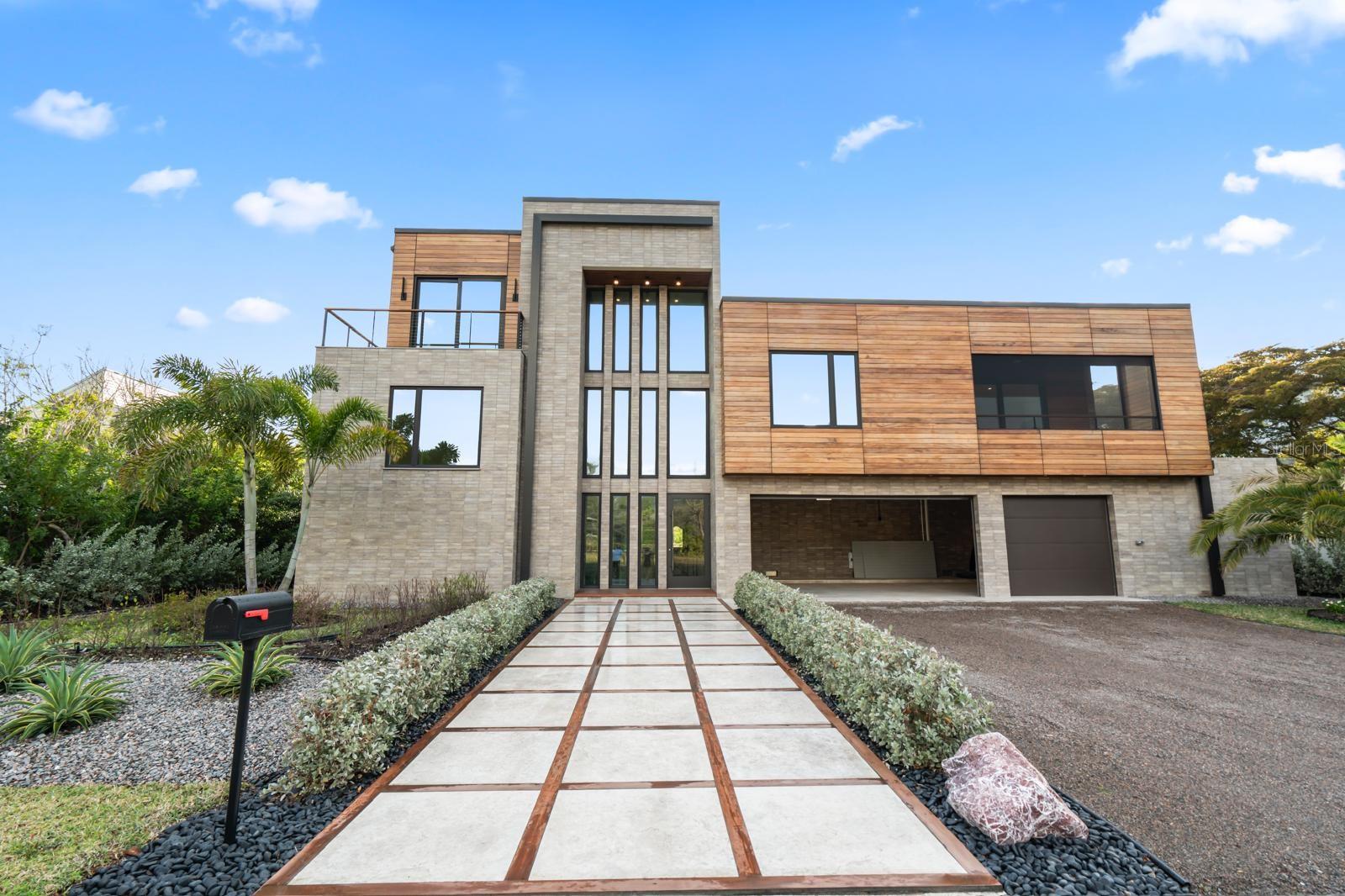 A contemporary masterpiece awaits Your going to love this house !, constructed in 2024 and completed in December of 2025 this newly built residence blends contemporary architecture with uncompromising craftsmanship. The craftsmanship, and finishing touches puts this property in a class by itself when making your buying comparisons.  Worth repeating….Your going to love this house!
Step into more than 3,800 square feet of modern design perfection ideally located in one of Longboat Keys most coveted neighborhoods. Just minutes on foot brings you to pristine beach access or a tee time at the prestigious Longboat Keys club. 
Seamless indoor- Outdoor living, a stunning floor to ceiling glass wall sets the tone from the moment you walk in revealing a private courtyard that feels like your own luxury resort, complete with an elegant pool, a relaxing spa, and a fully equipped outdoor kitchen and dining area.
This harmonious flow creates an exceptional living experience where the outdoors becomes an extension of the home .
Refined interiors inside , warm oak wood flooring runs throughout the home beautifully paired with stone accents , sleek cabinetry , and high end finishes.
The chef designed kitchen is crafted for culinary excellence and features quartzite countertops prized for their durability, beauty, and unmistakably high end character.
The primary suite is a serene retreat with glass walls overlooking the courtyard , a soaking tub , a separate shower, and generous storage.
Spaces designed for comfort the home offers five bedrooms including 
An in law suite with a kitchenette, private laundry, spacious bedroom, and walk in shower.
An additional bedroom on the main level with its own private balcony .
Upstairs two guest suites connected by a bright relaxation area with courtyard views through the floor to ceiling glass.
Striking modern architecture, the exterior showcases clean contemporary lines enhanced by rare hand selected stone and rich custom woodwork. 
Come visit this spectacular offering.
..