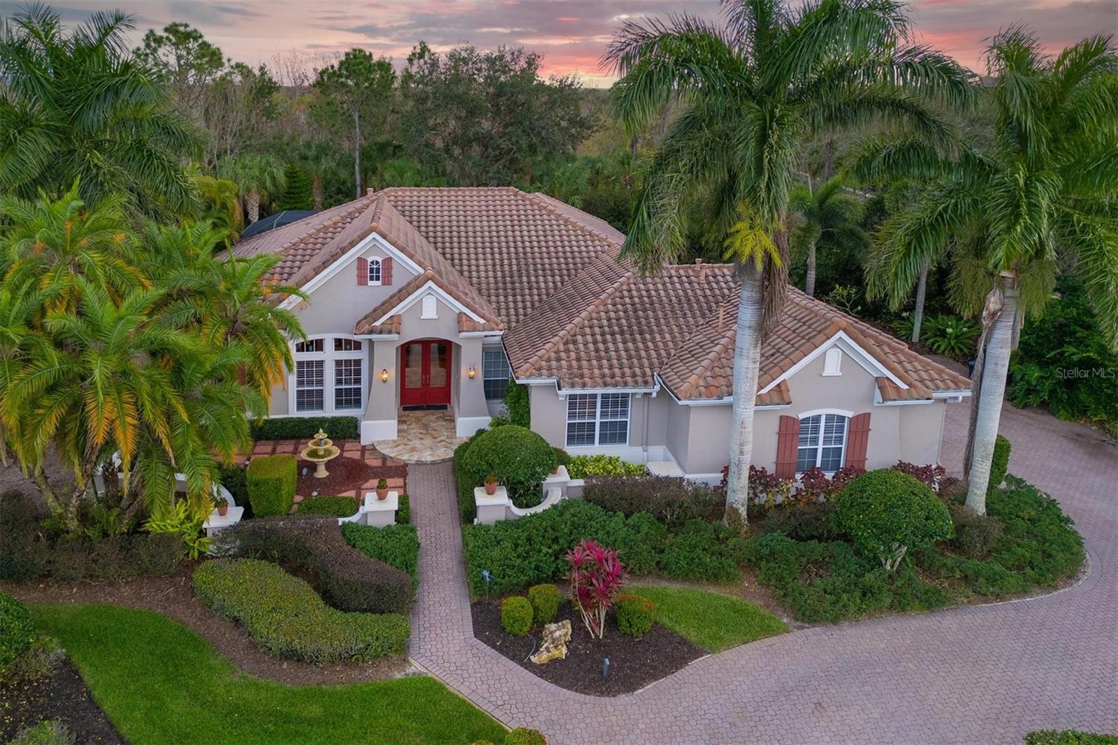 Locals affectionately call this one-of-a-kind luxury estate "The Gingerbread House," a name that captures its unique architectural charm. Behind its distinctive exterior lies a fully modernized interior, thoughtfully updated to feature a combination of todays open living along with defined spaces. Natural light fills the living spaces, highlighting premium design choices like the jaw-dropping quartzite kitchen countertops. Beyond the cosmetic beauty, the home operates with peak efficiency thanks to major infrastructure updates, including one brand-new HVAC unit and another updated in 2020 plus and an energy-efficient tankless water heater. The luxury experience extends straight out to the private backyard oasis. The entirely refreshed pool area features a resurfaced pool and a modern saltwater filtration system. Alongside the pool, an outdoor kitchen transforms the patio into the ultimate venue for weekend barbecues and warm Florida evenings. Living here means gaining access to the vibrant, wellness-focused lifestyle of Waterlefe Golf & River Club in Bradenton. Life centers around The River Club, a bustling community clubhouse complete with a Restaurant, the Sunset Lounge, a fitness center, and a newly resurfaced heated, junior Olympic-sized saltwater pool. Residents enjoy a packed social calendar filled with daily fitness classes, card games, book clubs, and artist guilds. Convenience is built into the property's logistics. High-speed Wi-Fi, internet, and comprehensive cable TV are completely included in the HOA fees, and the CDD fees are already factored into the total tax amount. Located just outside tof Lakewood Ranch without paying the premium that comes along with it, the estate offers incredibly fast access to I-75 and the local Costco an about to Open Whole Foods, Aldi, Publix and an ever growing local culinary scene, making daily errands effortless. While golf memberships and marina boat slips are available for enthusiasts, they remain entirely optional, allowing you to customize your experience in this premier waterfront and golf community.  Come see why you will call the "Gingerbread House" your home!