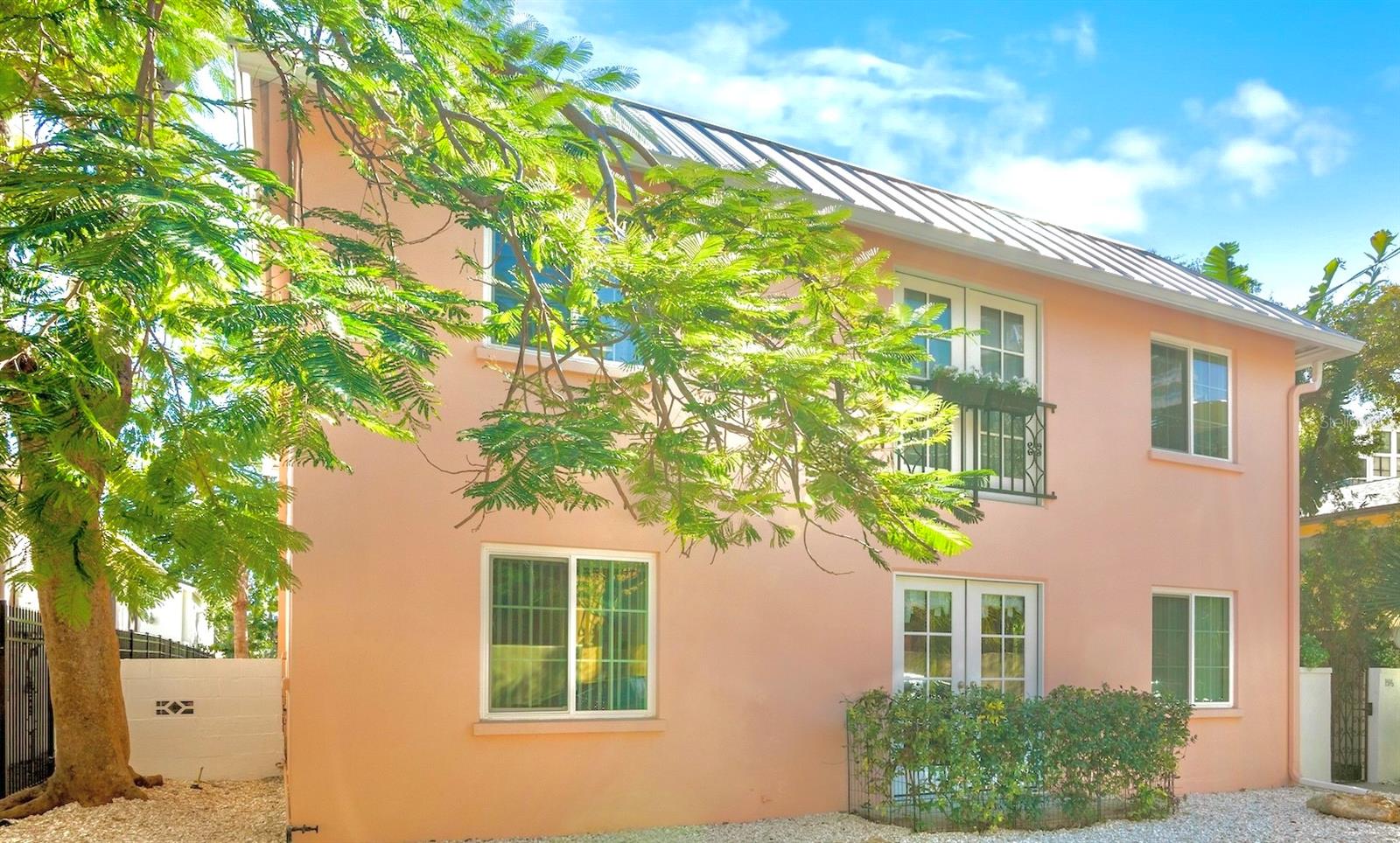 In the heart of desirable Burns Court in Sarasota, stands a captivating European-inspired Florida home. This DUPLEX offers a two bedroom, two bath residence downstairs and a three bedroom, three bath upstairs. 1516 Oak Street offers the unique advantage of downtown walkability coupled with the privacy of a fully fenced, meticulously landscaped yard adorned with native plants. This residence provides an ideal alternative to condominium living, granting residents exclusive private outdoor space for themselves and their pets without the financial burden of monthly condominium fees.

Indulge in the sun on the expansive upstairs balcony or unwind on the shaded patio. Prepare delectable charcuterie boards in the well-appointed kitchen, perfect for hosting happy hour gatherings, dinner parties, garden parties, or brunches. Each restful bedroom is equipped with an ensuite bathroom, ensuring privacy and convenience.

Situated conveniently near the Saturday Farmers Market, a variety of local restaurants, and the Sarasota Bayfront, this exceptional property offers unparalleled potential. Currently arranged as a fully furnished duplex, it also presents remarkable versatility as a family compound, an income-generating investment, or a potential conversion into a spacious single-family home.

The owner has invested significantly in high-quality upgrades to ensure the home’s move-in readiness, including:

- A new metal roof installed in 2022
- A replaced sewer line and relined pipes in 2023
- New windows, updated electrical systems, and a new air conditioning unit completed in 2025
- A well for irrigation to maintain the lush landscaping
- Natural gas connection
- Off street parking for 4 cars and a storage shed
- Completely fenced yard and landscape lighting.

  Furthermore, due to the property’s DTE zoning, there is potential to add another structure on the site, expanding the possibilities for future development. Selling turnkey furnished and ready to rent if desired.

Experience a remarkable lifestyle in Burns Court. Schedule a private tour today.