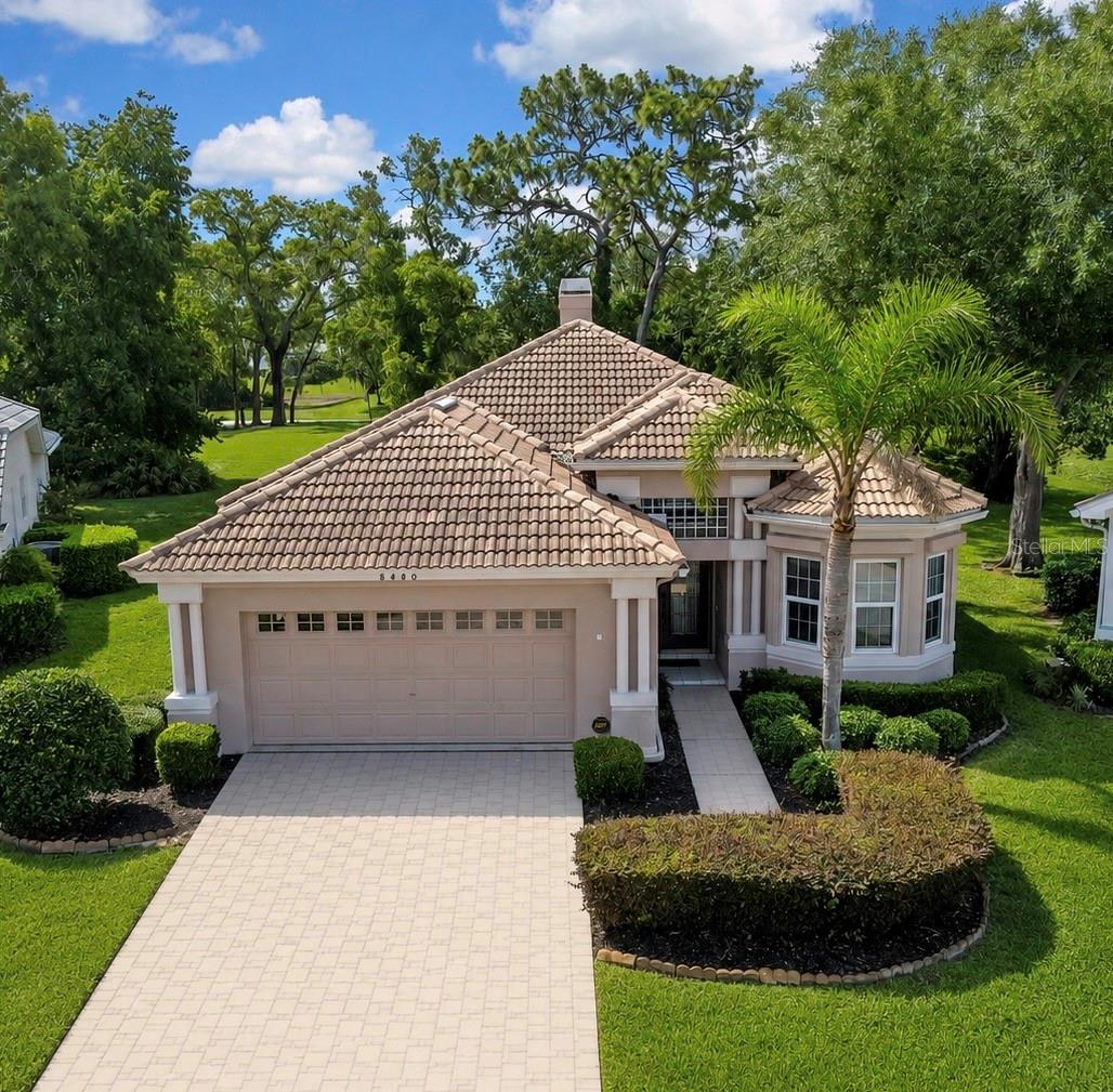 Set within the gated Glen Lakes Golf & Country Club, this 2,238 sq ft residence sits on a quiet cul-de-sac and overlooks the 18th tee—an exceptional setting that offers both privacy and scenic golf course views. Inside, the well-designed layout blends comfort, natural light, and an easy Florida lifestyle. Crown molding, abundant windows, and a smooth connection to the screened lanai create an interior that feels open and inviting.

The front-facing kitchen features black granite countertops, light cabinetry, black appliances, and a bright breakfast nook framed by bay windows. Its balanced contrast of light and dark finishes creates a clean, timeless look. Adjacent to the kitchen, the formal dining room provides an elegant setting for gatherings with decorative molding and space for a full dining suite.

The main living area is warm and spacious, centered around a built-in entertainment wall and a beautifully framed fireplace—a rare feature in Glen Lakes. Wood-tone flooring, wide windows, and generous seating areas contribute to a relaxed, refined atmosphere.

The primary suite offers a calm, private retreat with soft natural light, warm flooring, a neutral palette, and sliding doors to the lanai. It includes a walk-in closet plus a separate linen closet for added storage. The primary bath features a wide dual-sink vanity, expansive mirror, glass-enclosed shower, separate garden tub, and fresh, spa-inspired finishes.

A private guest wing off the foyer provides ideal separation for visitors. The guest bedroom is bright and comfortable with hardwood flooring and a soothing color palette, while the nearby bath includes a modern glass-enclosed shower and clean, neutral finishes. A separate den/office—or potential third bedroom—features French doors and convenient lanai access.

Outside, the home offers strong curb appeal with mature landscaping, stone-edged planting beds, and a welcoming front entry. The screened lanai extends the living space outdoors, creating a peaceful setting for morning coffee or evening relaxation. Additional features include a two-car garage, low-maintenance landscaping, and a Flood Zone X location for added peace of mind.

Residents who choose Social or Golf Club Membership enjoy access to a championship golf course, clubhouse dining, tennis and pickleball courts, fitness center, resort-style pool, and a full calendar of social clubs and community events—an active, welcoming environment known for its natural beauty and refined amenities.

Thoughtfully maintained and positioned within one of Hernando County’s premier gated communities, this home represents exceptional value in today’s market and an excellent opportunity for buyers seeking quality construction, a functional floor plan, move-in readiness, and the amenities of a true golf and country club lifestyle.