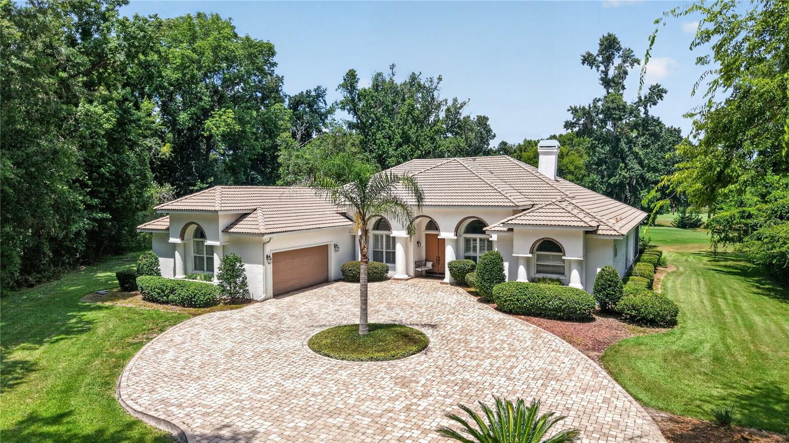 Sitting on top of one of the highest points in the Country Club of Ocala, this custom one owner home offers sweeping views of the 15th fairway. This thoughtfully designed floor plan with 3 bedrooms, 3 baths, a private office and an additional flex room, provides the flexibility to accommodate any lifestyle, whether you need a home office, fitness room, media space or playroom. Designed with entertaining in mind, the home features an impressive 720 square foot screened lanai stretching across the back of the home, creating the perfect place to gather with family and friends while enjoying views of the sparkling pool and well manicured golf course. The spacious family room is warm and inviting, centered around a fireplace and connected to the kitchen through a convenient pass-through and adjoining bar area. The kitchen has custom wood cabinetry with an abundance of space and opens to a charming breakfast room highlighted by a large bay window overlooking the backyard and pool. The generously sized primary suite is complete with its own fireplace, walk-in closet and an en suite bath featuring double vanities, a soaking tub and a separate walk-in shower. Two additional bedrooms each enjoy convenient access to their own bathrooms, providing privacy for family or guests. Just beyond the screened lanai, the open air pool w/spal provides the perfect place to cool off and relax in the Florida sunshine. Set back on the oversized 1.16 acre lot, this home has a long driveway with pavers that leads to the 2 car garage with an additional garage door on the backside for golf cart access. This home has been well maintained and is ready for its next chapter!