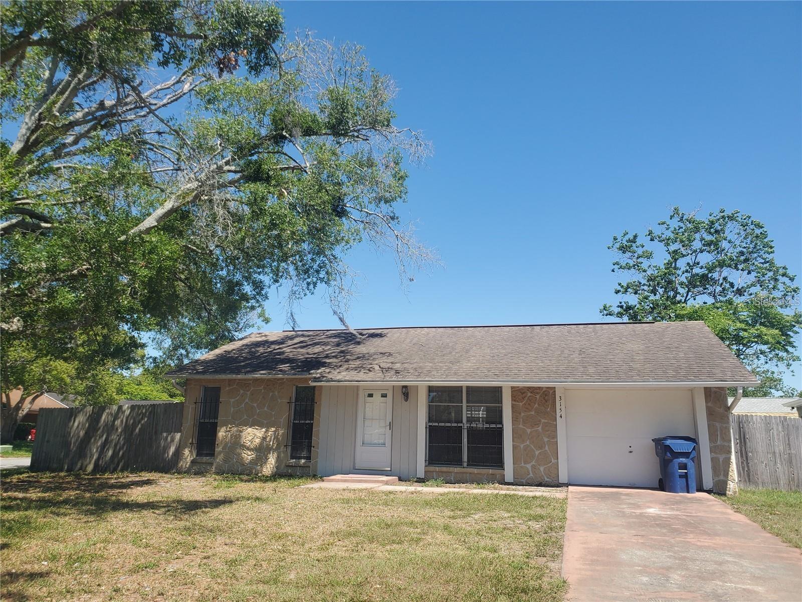Don't miss this incredible opportunity to rent a beautifully updated single-family home located in the heart of New Port Richey! Nestled on a quiet, family-friendly street, on a corner lot, this move-in-ready home offers comfort and convenience. Originally a 2-bedroom home, the converted garage provides a spacious third bedroom. Inside, you'll find a brand-new kitchen with newer appliances, beautiful and durable hardwood flooring, updated light fixtures, fresh paint throughout, vaulted ceilings, and an open-concept layout that creates a bright and inviting living space. Large sliding glass doors open to a huge screened-in Florida room—perfect for relaxing, entertaining, or enjoying the outdoors year-round. The home also offers plenty of closet space and a dedicated laundry room complete with a washer and dryer. Step outside to a large, fully fenced backyard with mature shade trees, providing the perfect space for children and pets to play. Conveniently located near excellent schools, kindergartens, shopping, dining, parks, and major roadways, this home combines peaceful neighborhood living with easy access to everything New Port Richey has to offer. Schedule your private showing today—this beautiful home won't last long!