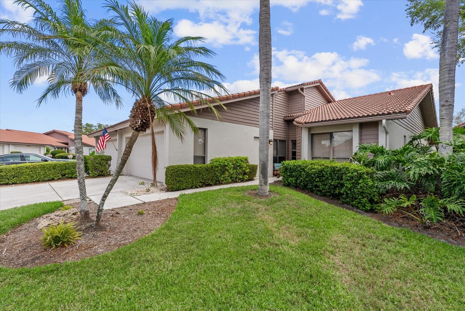 From the moment you step inside, tranquil lake views framed by mature trees and visited daily by waterfowl and native birds set the tone for this beautifully updated 2-bedroom, 2-bath villa in the sought-after Lakeshore Village community — just 15 minutes to the world-famous white sands of Siesta Key.  The open kitchen features quartz countertops, a designer backsplash, stainless appliances, updated lighting, and a new ceiling with fan. Both baths have been refreshed with granite countertops, new sinks and faucets — and the primary bath features a luxurious soaking tub. New flooring flows throughout — no carpet anywhere in the home. The expanded primary bedroom closet adds generous storage, and completely new AC ductwork was installed in the attic in 2024.  Three oversized skylights and abundant windows bathe the interior in natural light, while three large sliding glass doors retract fully to connect the living space — and the owner's suite — to a 23-foot tiled lanai, expanding the total living area to over 1,800 sq. ft. The guest bath features a tub/shower combination. A 2-car garage with overhead storage completes the package. This villa is being offered unfurnished.  Lakeshore Village delivers resort-style living with a heated saltwater pool, new pickleball courts, tennis courts, and a spacious clubhouse featuring a library, billiards room, and full kitchen. Monthly fees include basic cable TV, high-speed internet, pest control, roof maintenance, and grounds care. The community features winding private roads, no sidewalks, and convenient private access to Beneva Road. Rentals are permitted, and the location puts restaurants, shops, and medical offices within easy reach.
