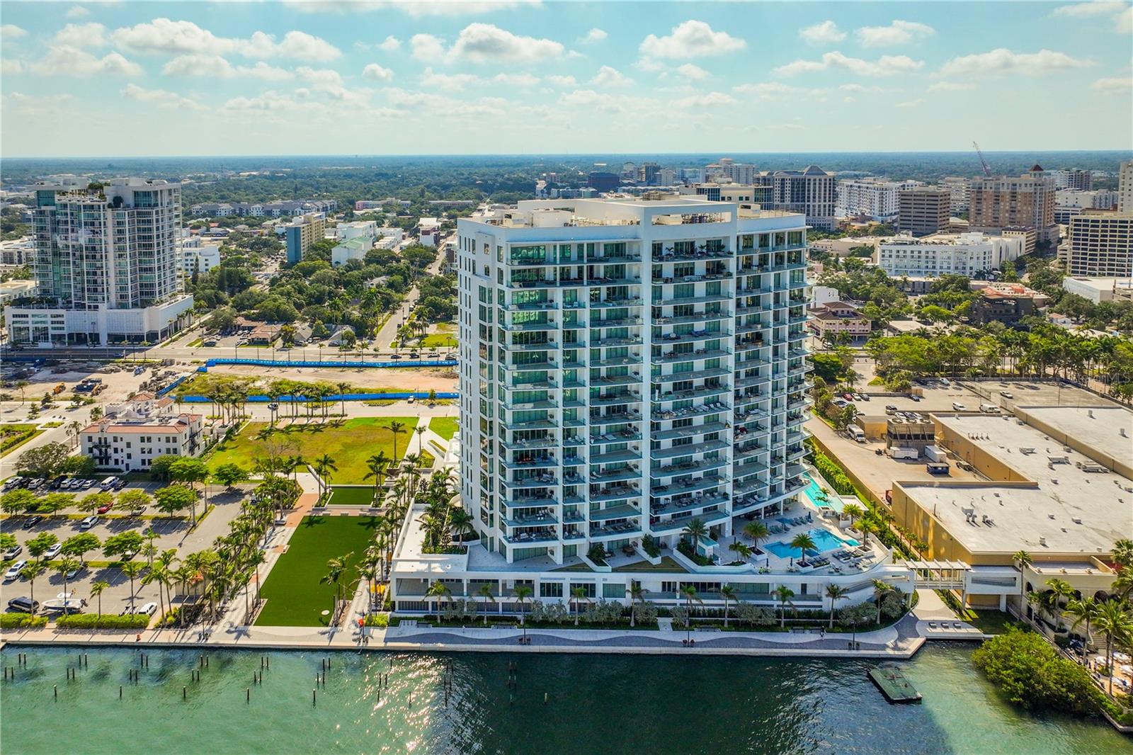 Indulge in the pinnacle of sophisticated waterfront living in the prestigious Sarasota condominium community, The Ritz-Carlton Residences. This luxurious retreat, situated in the most coveted location within the building, offers a host of legendary services and amenities.

Upon entering the private elevator-accessed foyer, thoughtfully placed at the base of the elevators and including two premium parking spaces, you'll immediately appreciate the meticulous attention to detail and enduring elegance. This exceptional residence features three bedrooms, three and a half bathrooms, and over 3,700 square feet of living space. The open-concept floor plan seamlessly connects communal areas with ensuite accommodations.

Additionally, nearly 1,000 square feet of patios provide an ideal blend of family comfort and grand-scale entertainment. Natural light bathes the interior through floor-to-ceiling glass on three sides, framing stunning views of Sarasota Bay, the vibrant cityscape, and the expansive Gulf of Mexico.

Adjacent to the living and dining spaces, the kitchen is a masterpiece, showcasing quartz countertops, sleek cabinetry, top-tier appliances, and a spacious island with captivating waterfall edges. A well-appointed wet bar adds to the allure, making it the perfect setting for cocktail hour.

The master bedroom is a tranquil sanctuary, complete with custom built-ins and easy access to the lanai for your morning coffee ritual. Step out onto the open balcony, where a sleek glass railing ensures unobstructed views of the world-class panorama, including the water, city skyline, and breathtaking sunsets.

The resort-like pool area beckons you to unwind in a haven of relaxation, featuring ample space for sunbathing, a poolside grill, and an outdoor dining area for lavish alfresco meals. The Ritz-Carlton Residences, Sarasota, offers a comprehensive array of resort-style amenities, including a fitness center, lap pool, a separate lounging pool with a hot tub, a club room for social events, a game room, poolside grilling facilities, and access to the hotel and spa. Additionally, 24/7 valet service ensures your every need is met.