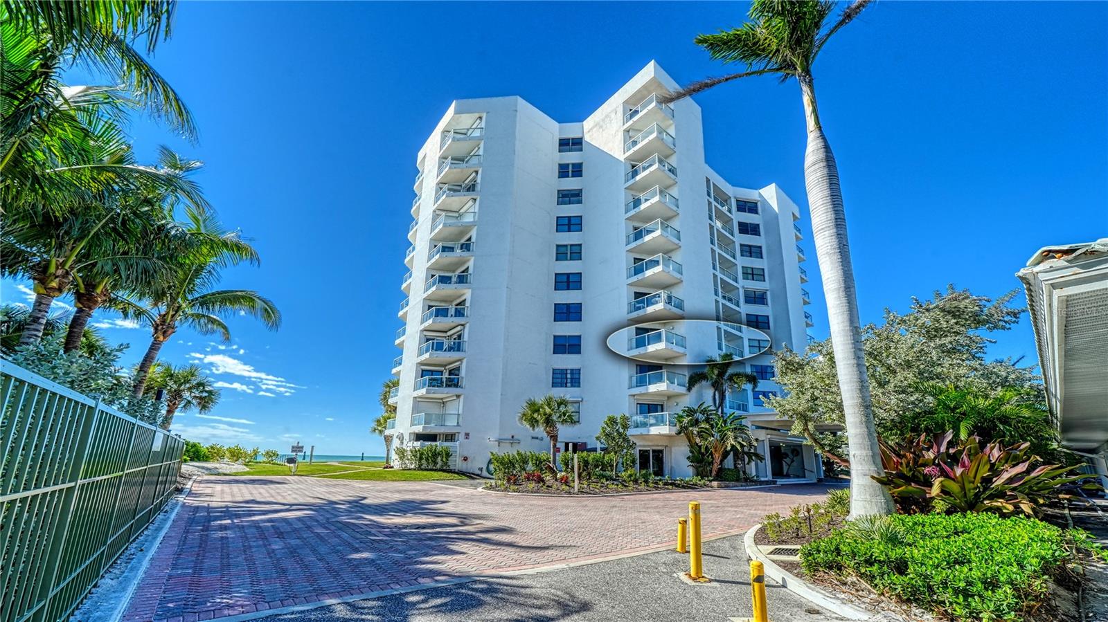 Experience refined coastal living behind the gates of the Longboat Key Club at Privateer South — a serene waterfront retreat where the Gulf sets the rhythm of each day. This exclusive Longboat Key enclave blends timeless Old Florida charm with resort-style amenities. Residents enjoy access to the Longboat Key Club’s championship golf, tennis, deep-water marina, fine dining, and private beach club, while Privateer South offers intimate beachfront living in a 12-story tower at 1000 Longboat Club Road.

This fourth-floor corner residence is a fully renovated two-bedroom, two-bath home that captures the essence of coastal elegance. Floor-to-ceiling windows and sliding glass doors open to wraparound balconies with eastern, southern, and partial Gulf views. Begin your mornings with sunrise over Sarasota Bay and the Intracoastal Waterway, as soft hues of pink and gold fill the open living and dining spaces. By afternoon, enjoy sweeping southern views of powder-white sand and turquoise Gulf waters, accompanied by the gentle sound of waves.

The interior renovation reflects modern sophistication and comfort. A sleek galley kitchen with quartz countertops, stainless steel appliances, and custom cabinetry flows seamlessly into the bright living-dining area. Neutral tones, shiplap accents, and high-end finishes create an inviting, light-filled space ideal for entertaining or relaxing. The primary suite features desirable southern exposure and a refreshed en-suite bath with dual vanities and a walk-in shower. The second bedroom offers flexibility as a guest room, office, or private retreat, with the guest bath refreshed as well, in a clean, contemporary style.

Daily living feels effortlessly indulgent. From the lobby, take the elevator to the heated Gulf-front pool and spa, complete with lounge seating overlooking the shoreline. Manicured pathways lead to private beach access, where dunes, complimentary chairs and umbrellas, and uncrowded sands create the perfect setting for sunset walks and frequent dolphin and pelican sightings. Residents also enjoy beachside grilling, on-site tennis, and the simple pleasures of Gulf coastal living.

Gated security, covered parking, and the low-density South tower — with approximately 62 residences — provide both privacy and a welcoming community atmosphere shared by seasonal and full-time residents alike.

Evenings on the balcony are unforgettable, with brilliant sunsets fading into star-filled skies over the Gulf. Inside, the open layout invites relaxed dinners, quiet reading, and peaceful nights accompanied by the sound of the water. This beautifully renovated corner residence offers the perfect balance of comfort, elegance, and breathtaking scenery in one of Florida’s most sought-after barrier island communities.