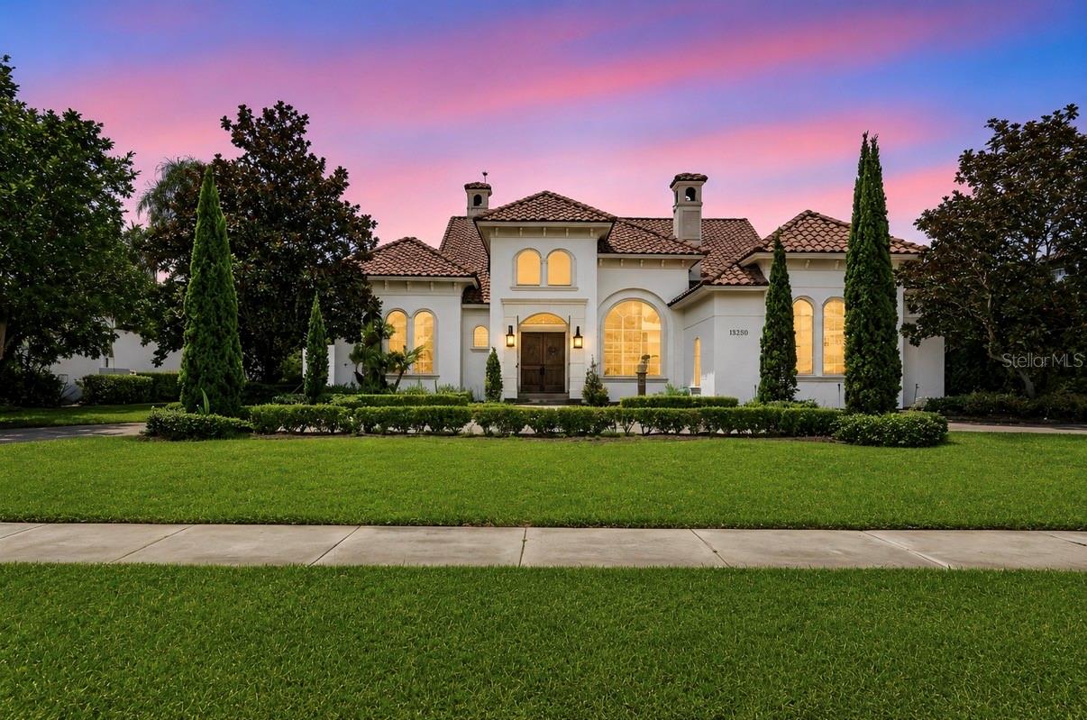 Exceptional custom estate in the exclusive guard-gated community of Bellaria featuring 6 bedrooms, 7 full bathrooms, 1 half bath, and a floor plan designed for both everyday living and entertaining. Positioned with pond views and no front neighbors, this residence has been recently painted inside and out and offers quality craftsmanship throughout.
The main living areas showcase travertine flooring, while the gourmet kitchen is appointed with custom Bosby cabinetry, stone countertops, a paneled built-in refrigerator that blends seamlessly with the cabinetry and an oversized walk-in pantry with direct access to the interior laundry room. The custom Bosby cabinetry continues into the family room, creating a cohesive, high-end design.
The thoughtfully designed layout provides exceptional privacy, with no bedrooms sharing a common wall. The spacious primary suite is located on the first floor fqacing the pool/backyard with a spaccious walk-in closet, upstairs you'll find 2 bedrooms and a dedicated movie theater, with the theater seating conveying with the sale.
The outdoor living space is designed for year-round enjoyment, featuring a resort-style pool, covered lanai, summer kitchen, and a bedroom overlooking the pool, ideal for guests or multigenerational living. Mature privacy hedges surround the backyard, creating a secluded outdoor setting.
Located just minutes from Winter Garden Village, major highways, top-rated schools, restaurants, shopping, and Orlando's world-class attractions, this exceptional home offers luxury, privacy, and convenience in one of Windermere's most desirable communities.