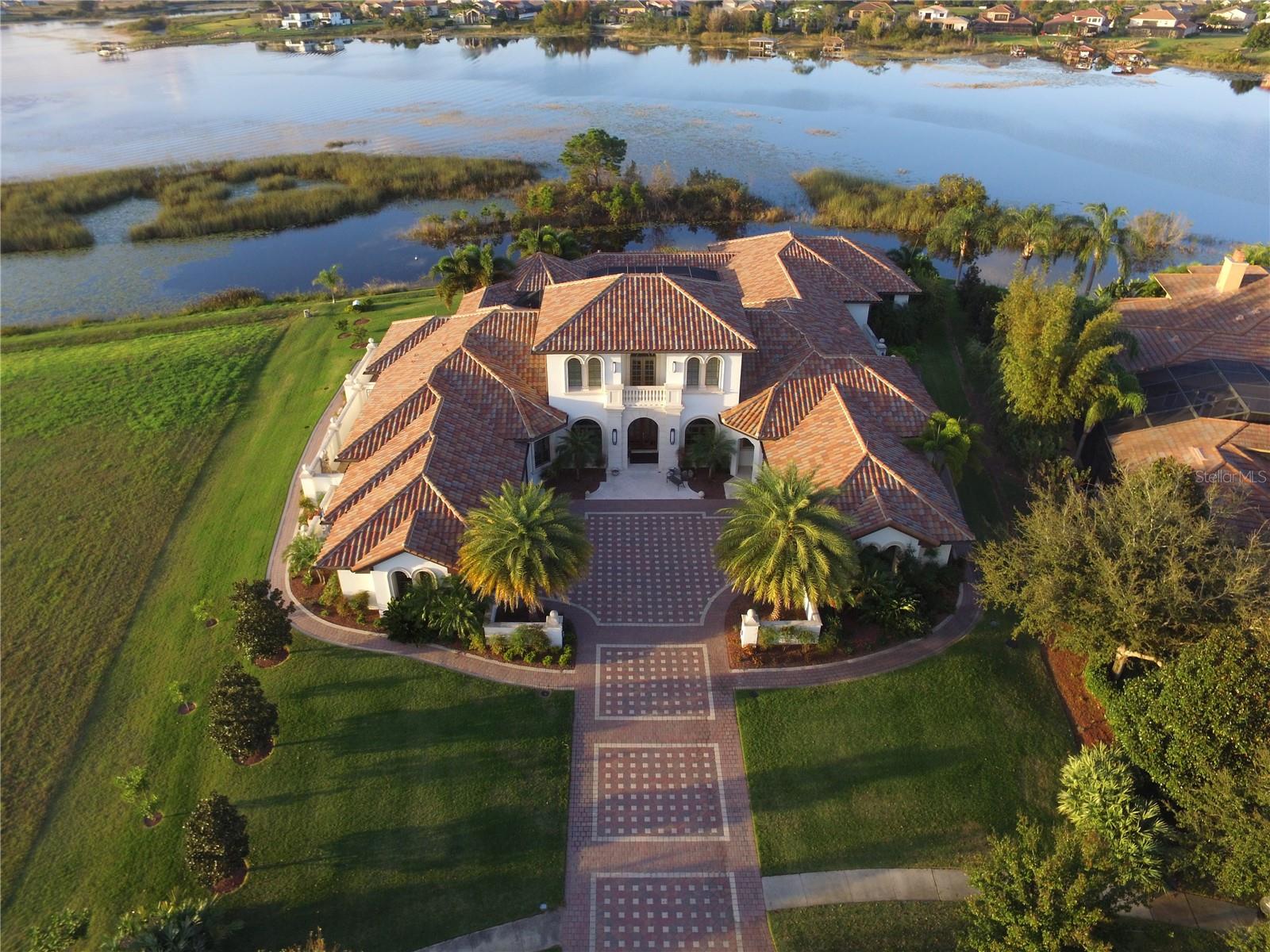 ESTATE SALE, full renovation needed.  Introducing a waterfront masterpiece estate in a truly unique setting--with lake frontage in both the front and rear of this exquisite home in the gated Isles of Lake Hancock community. 
This stunning custom-built home offers expansive living spaces, and a flow designed to take advantage of Florida's outdoors, with the primary suite, living room, great room all opening to the large, covered lanai and screen enclosed lakeside pool. The master suite enjoys complete privacy from the rest of the house. Masterfully crafted by a top MCBC builder.
Lake Hancock is a chain of three lakes availing pristine waters with miles of shoreline for boating and is a water sports paradise--famous for its ideal water skiing conditions, there are two slalom courses on the lake. The Hamlin town center plans include docks for water access to restaurants, shops and a movie theater. All while only ten minutes from Disney, and in close proximity to downtown Winter Garden, Windermere, and the world-famous attractions of Orlando. Come and see why this very private gated oasis has seen such little turnover, enjoying unmatched tranquility while just minutes from so much.  Estate sale, no Seller Disclosure available.