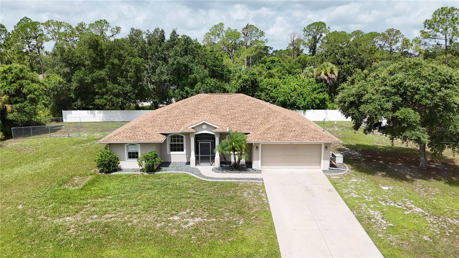 **TAKE A STROLL THROUGH YOUR NEW HOME WITH THE 3D INTERACTIVE VIRTUAL TOUR!** Welcome to your own private Florida retreat! This beautifully maintained 3-bedroom + DEN, 2-bath, 2-car garage POOL HOME situated on a DOUBLE LOT with a 2022 ROOF perfectly blends comfort, style, and functionality. Outstanding curb appeal welcomes you with lush landscaping, green grass, palm trees, decorative curbing, river rock, blooming hibiscus, and a screened front entry. Step inside and fall in love with the spacious open floor plan featuring vaulted ceilings in the Great Room and a split-bedroom layout that offers both privacy and functionality. Through French doors, you'll find a versatile bonus room perfect for a home office, family room, craft room, or game room. Across the foyer, the formal dining room is filled with natural light and provides the perfect setting for family dinners or holiday gatherings. Ceramic tile flooring flows throughout the home, making cleanup easy while offering durability for pets and everyday living. The gourmet kitchen is the heart of the home, featuring abundant cabinet and counter space, a large closet pantry, breakfast bar, decorative plant shelves, reverse osmosis system, and all appliances included. Perfectly positioned overlooking the main living areas, you'll always be part of the conversation while preparing meals or entertaining guests. The adjoining dinette overlooks the sparkling heated pool, creating the perfect spot to enjoy your morning coffee or unwind at the end of the day. The oversized owner's suite is a private retreat complete with dual walk-in closets, sliding glass doors leading to the lanai, and an en-suite bath featuring dual vanities, a spacious walk-in shower, and a relaxing garden tub. Two additional guest bedrooms offer ceiling fans, generous closet space, and easy access to the full bathroom with a tub/shower combination and access to the pool area. An inside laundry room conveniently located off the kitchen adds even more functionality. Recent updates include a 2026 A/C, 2022 roof, new well (2021), new well pump (2025), and pool resurfacing (2019). Storm season is no match for this home with a whole-house generator connected to an underground propane tank, roll-down Tefla hurricane shutters on the lanai, and a newly installed hurricane-impact front door. Sliding glass doors lead to your own backyard paradise and the spacious screened lanai is perfect for outdoor dining, relaxing, or entertaining family and friends, while the sparkling heated pool is ready for year-round enjoyment. A vinyl privacy fence surrounds the backyard, and a separate chain-link area provides the perfect space for pets to run and play. Conveniently located near Coco Plum Village, shopping, dining, golf courses, churches, top-rated schools, the North Port Aquatic Center, Boca Grande, Englewood Beach, Charlotte Harbor, Charlotte Sports Park (Tampa Bay Rays Spring Training), and Wellen Park (Atlanta Braves Spring Training). Quick access to US-41 and I-75 makes commuting throughout Southwest Florida a breeze. Don't miss your opportunity to own this move-in-ready home offering a DOUBLE LOT, heated pool, major updates, exceptional storm protection, and an unbeatable location. Schedule your private showing today and start living the Florida lifestyle you've always dreamed of!