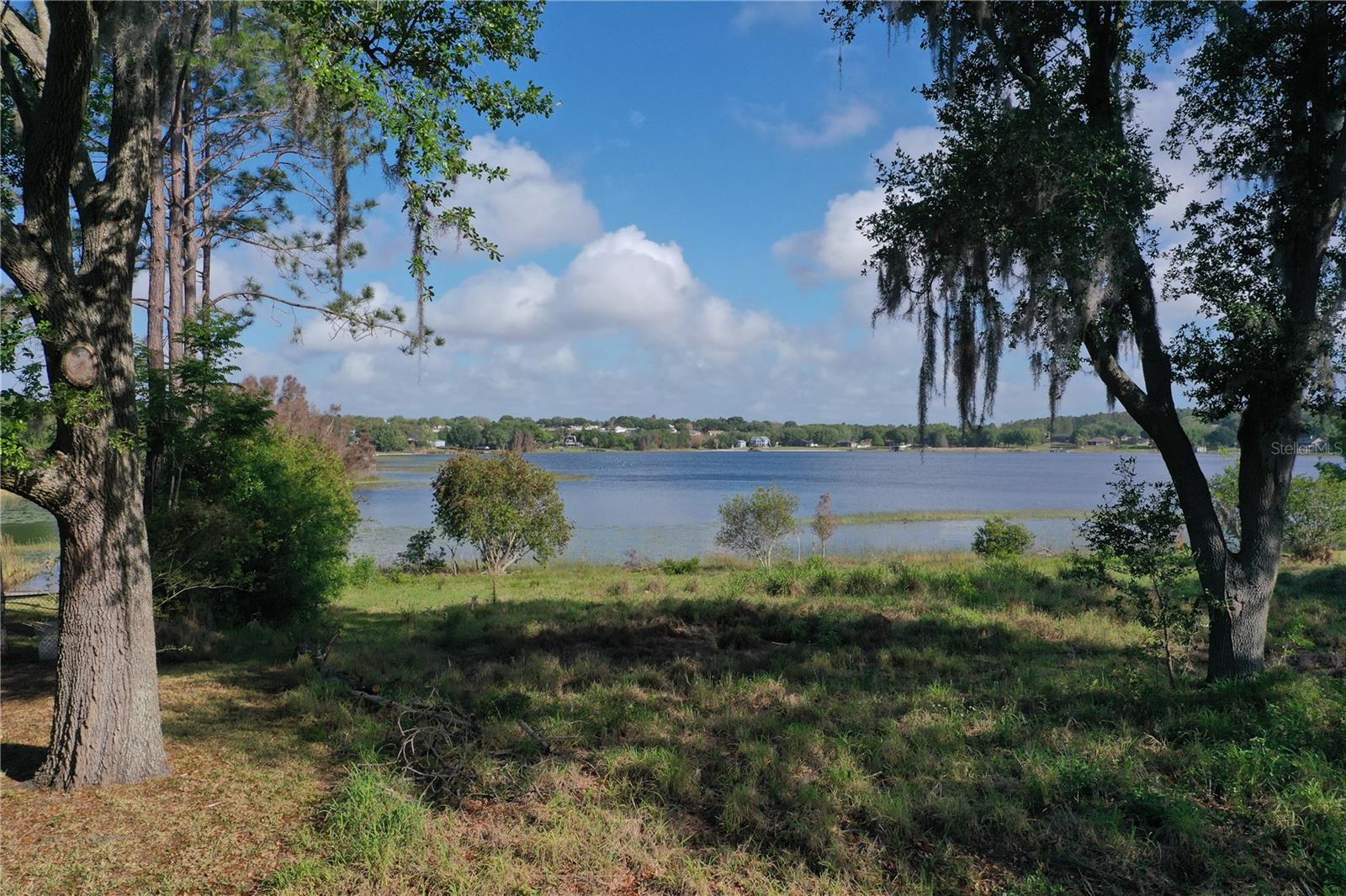 Lakefront vacant land on the natural Lake Sawmill, a well-known setting for lake lifestyle enthusiasts and waterski with two slalom courses on the lake. Survey available, the lot includes 8,300 sqft of designated buildable area, offering clarity and confidence when planning construction. The property offers a desirable layout with no neighbor on one side, providing additional privacy and flexibility for a future build. A community boat ramp is located on the west side of the property, offering convenient access to the water. Located just minutes from Downtown Clermont and Highway 27, with easy access to shopping, dining, and everyday amenities, and approximately 38 miles to Orlando International Airport (MCO), this property combines a quiet lakefront setting with proximity to key Central Florida locations. Low annual HOA fees contribute to manageable holding costs while maintaining the community. A great opportunity for buyers looking to build a primary residence, second home, or secure a spacious lakefront lot in a limited inventory setting.