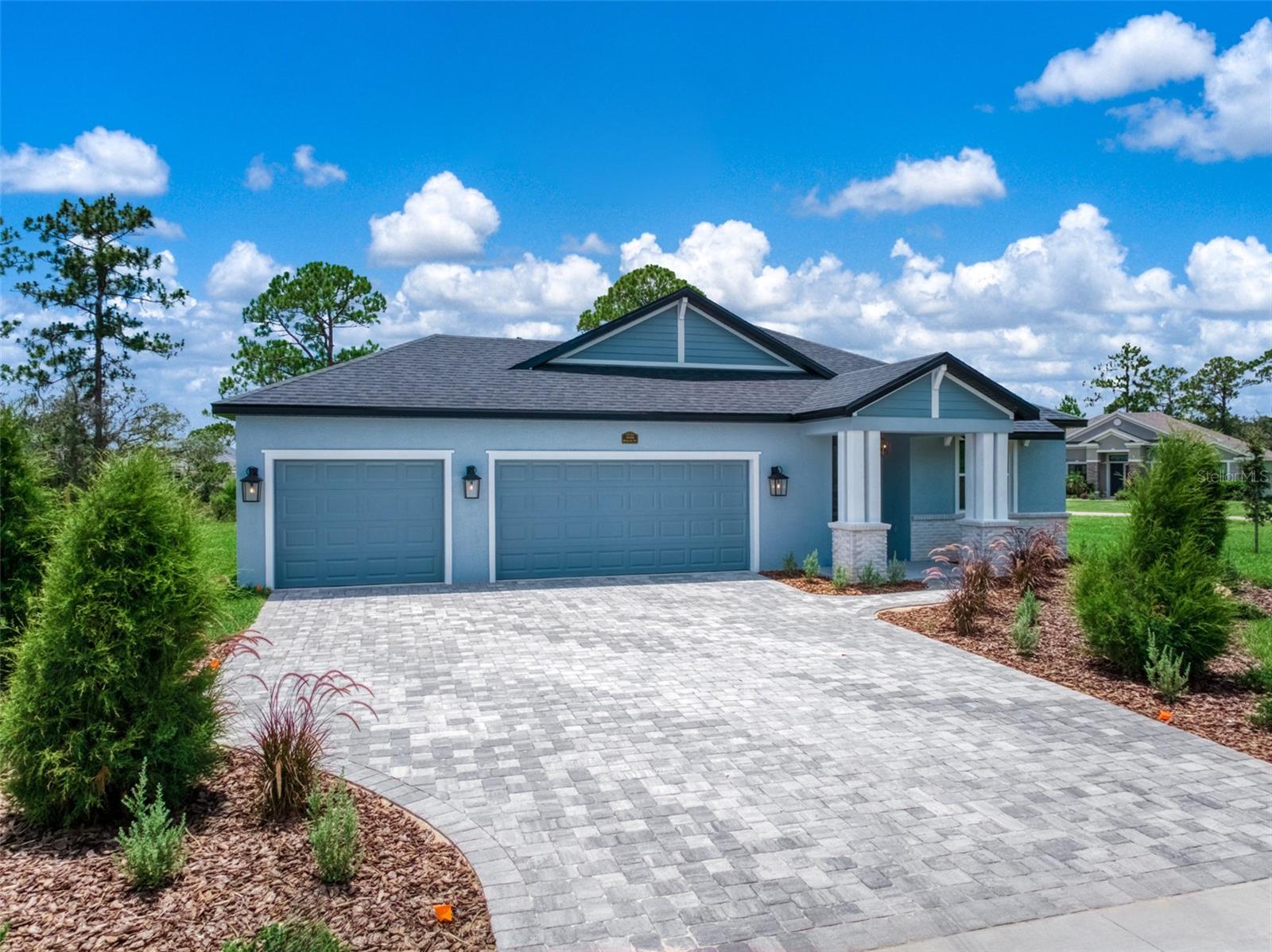 MOVE-IN READY NEW Construction by Amaral Homes – Quality Craftsmanship, Exceptional Value Completed and ready for immediate occupancy, this beautifully designed Oak floor plan by Amaral Homes combines thoughtful design, upscale finishes, and everyday comfort in a spacious 4-bedroom, 3-bathroom home. Designed with flexibility in mind, the private fourth bedroom and full bath are tucked away from the main living areas, creating the perfect guest suite, home office, or multi-generational living space. The impressive 13' x 15' owner's suite is privately situated at the rear of the home and offers a luxurious retreat featuring a spacious walk-in closet and a spa-inspired en-suite bath complete with dual vanities, granite countertops, a stunning tiled walk-in shower, and a relaxing rain shower head. From the moment you enter, you'll appreciate the open-concept design highlighted by 9'4" ceilings throughout and elegant tray ceilings in both the living room and owner's suite. Premium tile flooring flows through the main living areas, complemented by 5" baseboards, two-panel doors, and carefully selected designer fixtures and finishes. Every bathroom showcases ceramic tile flooring and beautifully tiled tub and shower surrounds. The heart of the home is the stunning gourmet kitchen, where you'll enjoy views of the backyard while preparing meals. Features include a large 9-foot island with bar seating, soft-close cabinetry, gorgeous granite countertops, a stylish tile backsplash, pendant lighting, and even a convenient pot filler for the home chef. Additional thoughtful details continue throughout the home, including a functional drop zone located between the laundry room and guest suite, complete with cabinetry, granite countertops, and a full tile backsplash. Need extra space for vehicles, toys, or a golf cart? The oversized 3-car garage includes a dedicated golf cart charging outlet and is complemented by an attractive concrete paver driveway. Situated on a generous corner lot, the home features professional landscaping, irrigation, and a spacious 10' x 28' covered/screened in lanai—perfect for enjoying Florida's beautiful weather and entertaining family and friends all year long. Best of all, ALL appliances are included, making your move even easier. Simply bring your furniture and start enjoying the lifestyle you've been dreaming of in a beautiful new Amaral home.