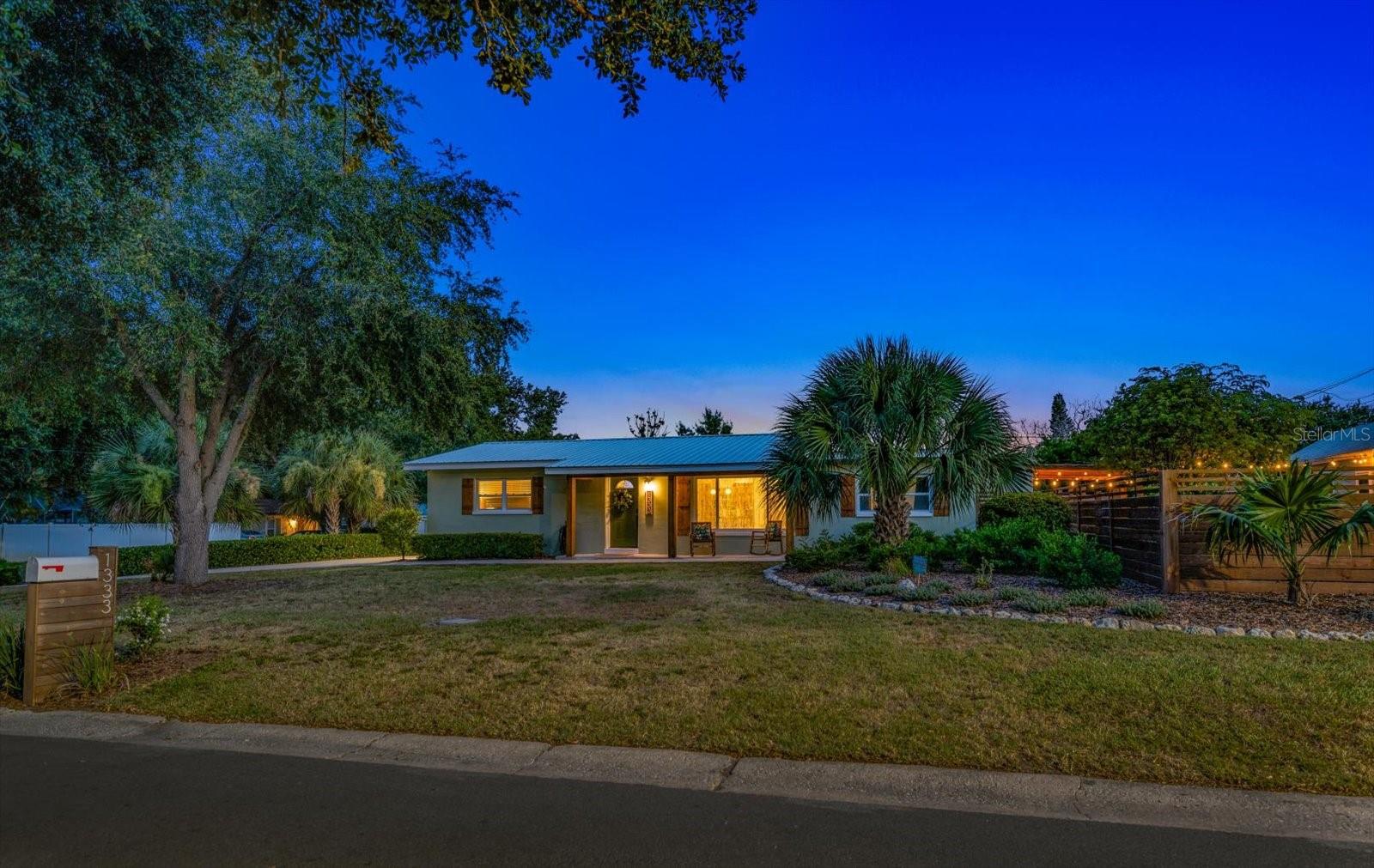 Welcome to 1333 Bayview Drive — a thoughtfully reimagined residence blending timeless Florida character with curated updates, flexible living spaces, and an outdoor setting designed to be enjoyed year-round. Situated on a spacious corner lot in a non-flood zone, this beautifully maintained all-block home offers 4 bedrooms, 2 bathrooms, and approximately 1,829 square feet of move-in ready living in one of Clearwater’s most convenient locations.

From the moment you arrive, the home makes an impression with its inviting front porch, warm architectural wood accents, mature landscaping, and durable metal roof. Inside, a series of intentional renovations create bright, open living spaces with a clean, elevated aesthetic and a layout designed for both everyday living and effortless entertaining.

At the center of the home is an expansive open-concept kitchen featuring granite countertops, abundant cabinetry, stainless appliances, generous prep space, and seamless connection to the surrounding living and dining areas. Recessed lighting, updated finishes, and cohesive flooring throughout create a polished yet comfortable atmosphere.

Multiple gathering spaces provide flexibility to suit changing needs—whether hosting friends, creating a play space, working from home, or simply enjoying quieter moments. A secondary living room with a wood-burning fireplace adds warmth and character rarely found in homes of this style.

The outdoor spaces feel intentionally designed rather than simply maintained. Professionally planned landscaping emphasizes privacy, sustainability, and year-round enjoyment with mature trees, established native plantings, inviting seating areas, raised garden space, and a beautifully integrated outdoor entertaining environment. Whether enjoying morning coffee beneath the covered front porch, dining outdoors under the pergola, or gathering around the firepit in the evening, the property offers a lifestyle that feels both relaxed and refined.

Recent improvements provide peace of mind and include updated windows, HVAC (2021), electrical panel (2021), hot water heater (2021), newer appliances, exterior improvements, and a recently completed flat roof section (2025), complementing the main metal roof.

Additional features include a detached Hardie-sided garage/shed, side double gate access, and a dedicated space ideal for boat or RV storage—an increasingly rare opportunity this close to Clearwater’s beaches and everyday conveniences.

Located minutes from Clearwater Beach, Eagle Lake Park, shopping, dining, and major thoroughfares, with no HOA and no flood insurance requirement, 1333 Bayview Drive delivers a rare combination of thoughtful updates, flexible living, and distinctive outdoor spaces in the heart of Clearwater.
