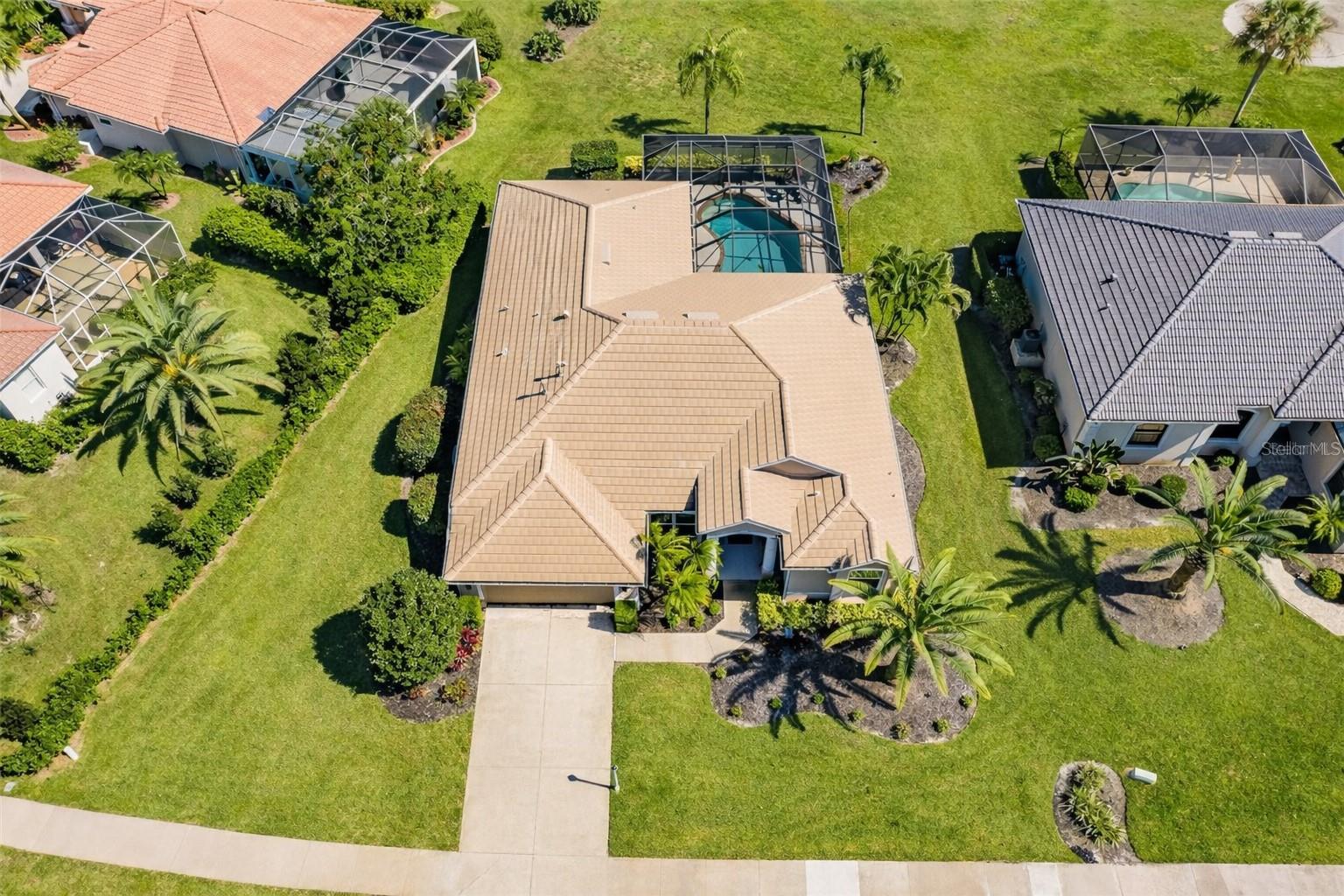 Assumable Mortgage at a very low rate 3.375% - Welcome to your Florida dream home in the highly desirable community of Bobcat Trail, offering serene water views of the Aqua Range Lake and a spacious, thoughtfully designed layout. This 4-bedroom, 3-bath residence features a split floor plan, high ceilings, and an abundance of natural light throughout.

The heart of the home is the expansive kitchen, complete with rich cherry wood cabinetry, solid surface countertops, stainless steel appliances, pantry, built-in desk, and a convenient butler’s pantry—perfect for both everyday living and entertaining. The open layout flows seamlessly into the main living areas and out to the screened-in lanai.

Step outside to your private pool oasis, featuring a recently updated heater and pump, ideal for year-round enjoyment. The oversized lot provides added privacy and peaceful lake views, creating a true retreat.

The spacious primary suite offers direct access to the pool, tray ceilings, plush carpeting, and dual walk-in closets. The en-suite bath includes dual vanities, a walk-in tiled shower, and a relaxing garden tub.

Additional highlights include a flexible layout with two bedrooms and a full bath on one wing, plus a separate fourth bedroom with pool bath—ideal for guests or a home office. Major updates provide peace of mind, including a 2020 tile roof, 2021 AC system, 2021 gas water heater. The home is also equipped with remote-controlled hurricane shutters, along with impact-rated front windows for enhanced storm protection.

With clean lines, neutral finishes, and move-in ready condition, this home offers the perfect blend of comfort, functionality, and Florida lifestyle living.