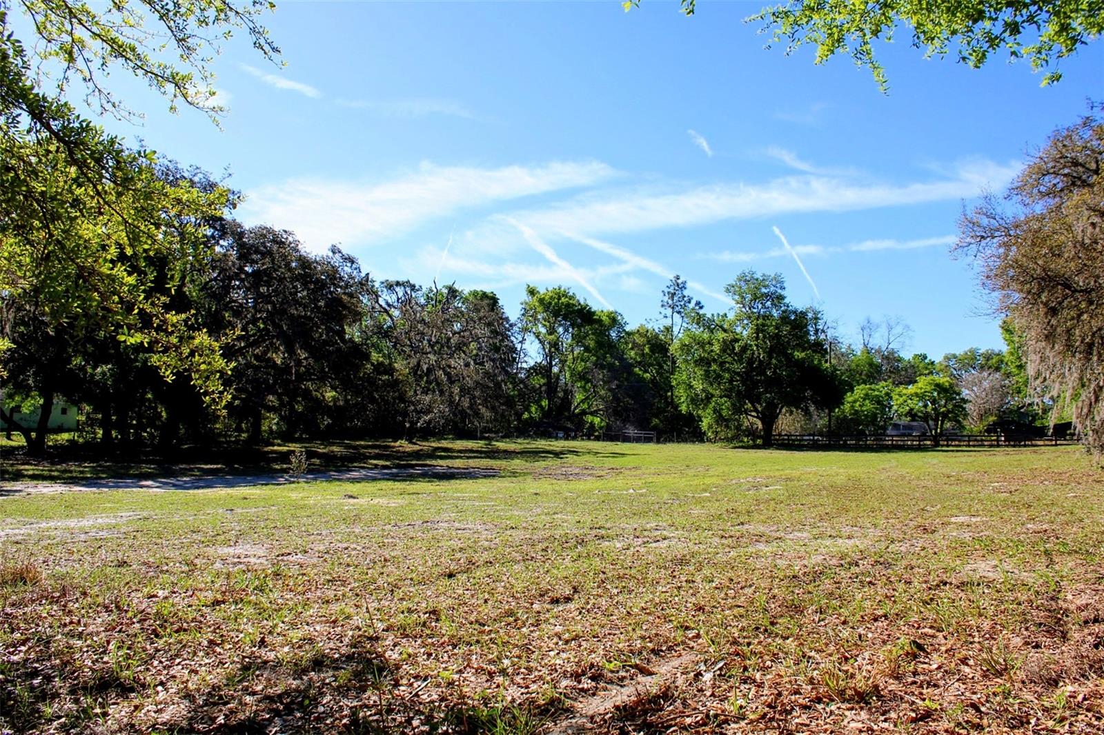 PRIME LOCATION! 2.4 acres nestled in the heart of the rolling hills in Dade City await your future dream home! This property is high and dry and allows plenty of room for animals, a barn,  pool, or a family compound!  The property features mature oak trees along the perimeter of the property providing maximum privacy but the property has been completely cleared down the middle, ready for your future home to be built! A brand new driveway/culvert has been installed, creating easy access directly from St. Joe Rd. but also features a secondary gated entrance at the back of the property. Almost fully fenced in, just needs a a front entrance gate!
The property can be divided into 2 parcels with a private entrance for each parcel already installed, and allows for one single family home to be built per acre (and animals if desired)!
Approximately 5 minutes to Historic Downtown Dade City where you can indulge in the small town charm with local culinary delights, breweries, shopping, parks, bike trails, drive in movies, festivals, Snowcat Ridge, and the new splash pad! Situated right near Happy Hill Rd. which provides easy access to I-75 only 5 miles away!  Approximately 20 minutes from Wesley Chapel where there is an abundance of shopping at 2 malls, endless dining options, hospitals, and the largest ice skating rink in the Southeast! Plenty of fun activities to do whether you immerse yourself locally in the small town living or drive a little further for larger amenities, you will remain tucked away in your own private country living to return home to.
Schedule a showing to view this gem today!

Please use GPS Coordinates: 28.364788,-82.236808 
Sign at property.