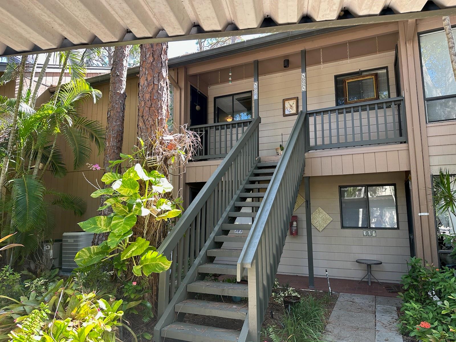 It is easy to enjoy the beauty of coastal waterfront living in Pelican Cove and this 2 bedroom/2 bath condo.  The open floor plan with high ceilings and natural light/skylights creates a spacious and inviting atmosphere.  The split floor plan includes a master bedroom with updated bathroom, walk-in closet and upstairs attic space.  As you drive past the gate, the lush tropical setting, fruit trees, bird watching and manatee sightings in the harbor will offer instant serenity and relaxation. Amenities include art studio, woodworking shop, sculpting garden, 6 pools, yoga, tennis, pickleball, water aerobics, biking, new exercise room and kayak launches to name a few activities. Enjoy an impressive offering of performing arts, annual art show, cinema & culinary club, bridge and fiber arts club.