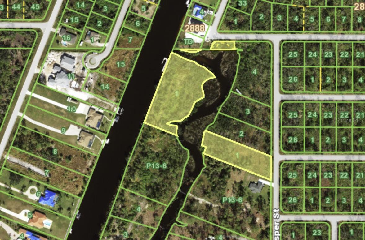 Welcome to one of the most unique waterfront properties in Charlotte County!  Located directly on the gulf access Apollo waterway, this 2.67-acre property offers direct access to the Myakka River with no bridges with only a short 5–10-minute boat ride.  The property gives you an opportunity to live on your own private island being the parcel is surrounded by water on 3 sides.  A tidal creek flows behind the parcel on the opposite side of Appollo waterway, and the creeks inlet flows just to the North side of the parcel connecting the Apollo to the creek, (see attached aerial maps). Your driveway from Casper Street will be your very own bridge over the creek providing not only privacy and extra security, but a uniqueness that rivals any property in the area. The parcel itself is 16 feet above sea level at its highest point providing sufficient elevation to build a home above any potential flood risk and eliminates the need to bring in any additional expensive fill dirt that is required on any new build.  There are 3 other adjacent parcels also available, which equal to 5.1 acres, (not including the creek and some wetlands), which if purchased together, give a discerning buyer an opportunity to own their own private waterfront direct gulf access compound with an island parcel for the main house directly on the Apollo.  Looking for a true unicorn to construct your dream home?  This is the one.
