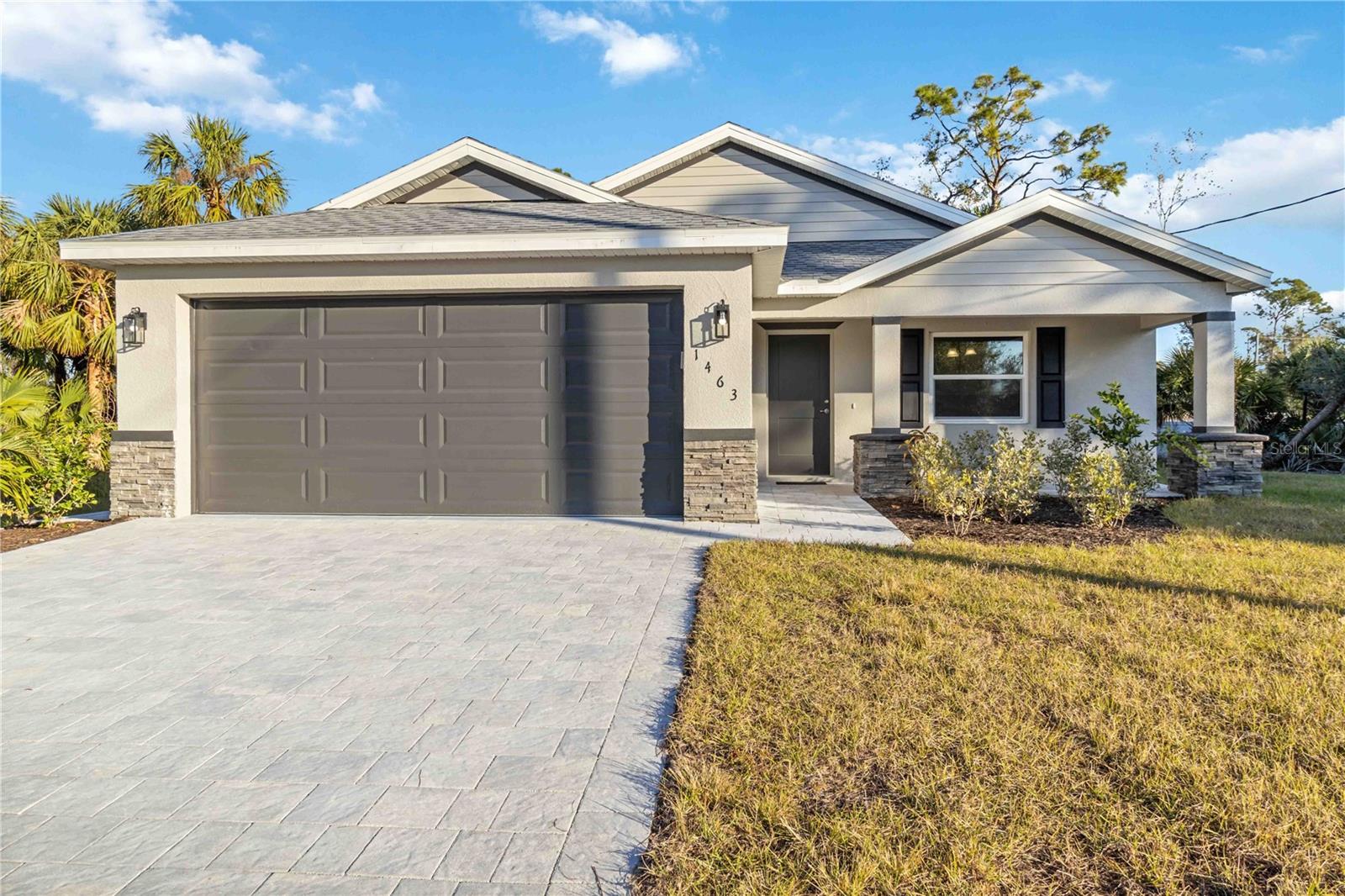 Welcome to this stunning, move-in ready new construction home in the desirable city of North Port, Sarasota County. Built by a trusted local builder, this home offers all the benefits of a custom build without the long wait times. Featuring 3 spacious bedrooms, 2 beautifully designed bathrooms, and a 2-car garage, this property is perfect for those seeking comfort and convenience. The home sits on Beautiful lot with a Greenbelt in the back of the property and is not in a flood zone, providing peace of mind and plenty of outdoor space. The stone accents and paver driveway create incredible curb appeal, while the front porch with a paver seating area is ideal for enjoying Florida’s sunny days. The screened-in lanai at the back provides a perfect retreat for relaxing outdoors. Inside, you'll find upgraded wood cabinets with soft-close drawers, an overmount rectangle sink, and high-end stainless steel appliances in the kitchen, along with a pantry and tile backsplash. The home is finished with luxury vinyl plank flooring throughout, and the bathrooms feature stylish tile floors with a tiled shower and glass door in the primary bath. The large walk-in closet in the master suite offers ample storage space, and all fixtures have been upgraded to provide a modern, polished feel. Additionally, the home is equipped with energy-efficient windows, helping to keep utility costs low. As a bonus, the builder includes a 2-year warranty and a 10-year structural warranty, offering added peace of mind. This beautiful home is ready for immediate occupancy, so don’t miss out on the opportunity to make it yours!