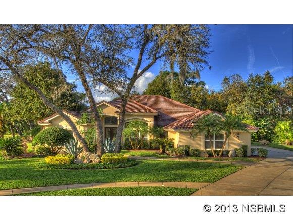 BEAUTIFUL HOME ON EXTRAORDINARY LOT, in prestigious Spruce Creek Fly-In. Located in a private, park-like setting on over  acre offering stunning landscaping, the property is bordered by a pond & conservation area. This elegant 4BR, 3.5BA residence has a tile roof & oversized, side-entry 3-car garage. Upon entering, the open floor plan offers exquisite formal areas & welcoming informal areas. The Family Room is expanded, with generous window, French doors & a gas fireplace. The spacious Kitchen offers granite counters, breakfast bar, planning center, walk-in pantry & a caf area overlooking the pool & yard. A spectacular Master Suite with double doors boasts a master bath with walk-in shower, soaking tub, dual vanities & a generous walk-in closet. This unique floor plan offers 2 expanded bedrooms & 2nd bathroom w/ walk-in shower, tub & double vanity. The 4th bedroom & bath are positioned perfectly to serve as a guest area or office. The screened lanai extends from a deep covered patio, offering a 36 heated pool & spa plus separate pool bath, perfect for the Florida lifestyle. This impeccable home features high ceilings, architectural details, crown molding, zoned HVAC, security system, intercom & large laundry room with a tub. Spruce Creek Fly-In, located close to shopping, restaurants, schools, interstate highways & recreation areas, is a staffed, gated community with country club membership options, an on-site caf and a private 4,000' runway. ;Water: City