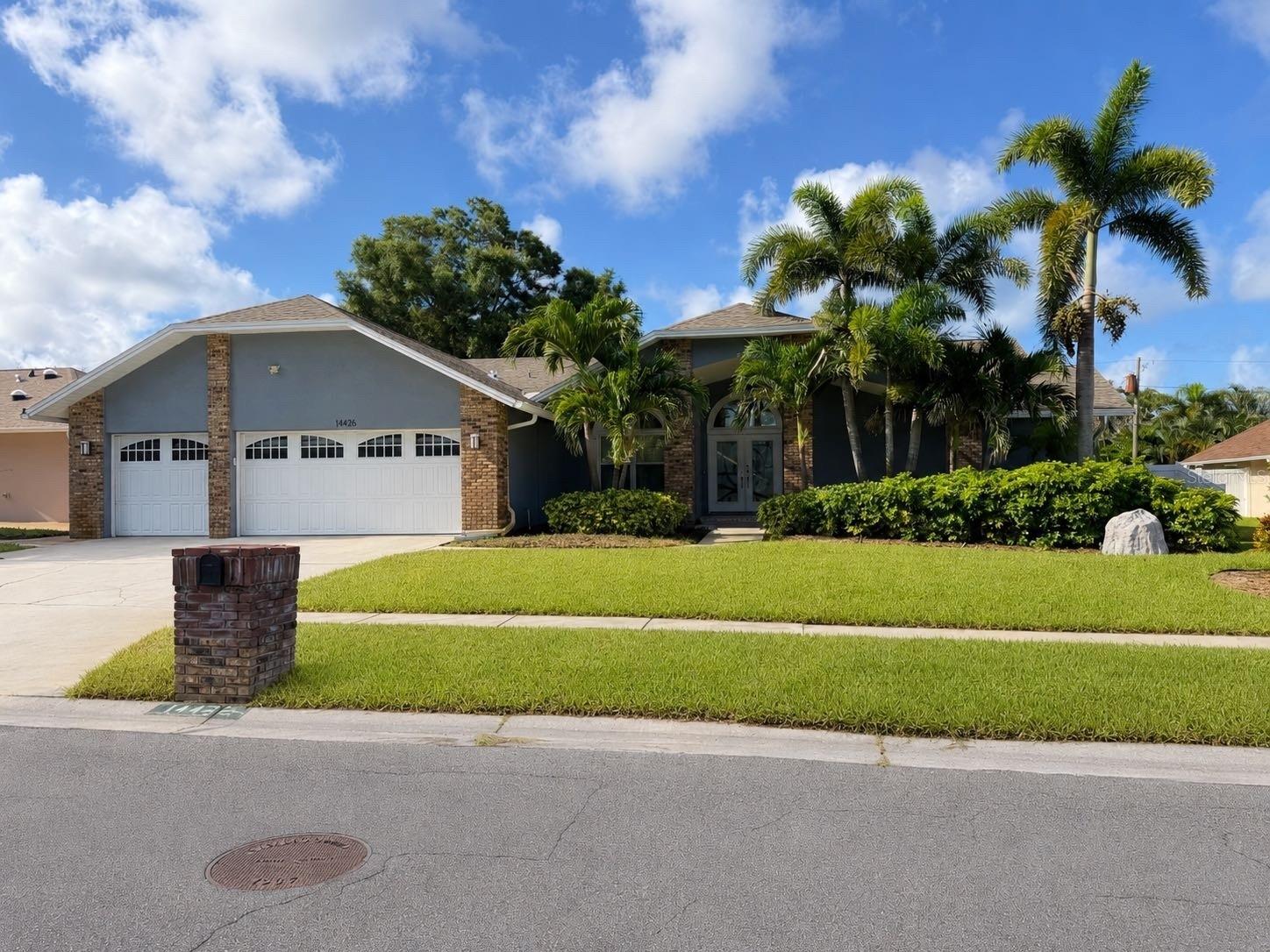 Welcome to refined comfort in the highly desirable Collins Estates. Nestled in a peaceful neighborhood just minutes from the sparkling Gulf beaches, this exceptional residence offers the perfect balance of luxurious living and a relaxed, family-friendly lifestyle. From the moment you enter, you are greeted by soaring vaulted ceilings, abundant natural light, and an inviting open layout. The spacious living room features sliding glass doors that seamlessly connect to the screened lanai and pool area. Designed for both everyday living and entertaining, the chef's kitchen showcases gleaming granite countertops, abundant cabinetry, a breakfast bar, stainless steel appliances, and additional space for casual dining. The adjacent family room features durable tile flooring and a cozy electric fireplace, creating a warm gathering space that flows effortlessly to the outdoor living area. Outside is your own private tropical retreat, complete with a screened-in pool and spa, where expansive sliding doors from both living areas invite seamless indoor-outdoor living under the Florida sunshine. A deep well irrigation system helps maintain the lush landscaping while providing an efficient and cost-effective water source. The primary suite serves as a private sanctuary with soaring ceilings, abundant natural light, beautiful wood flooring, and direct access to the lanai. It also features an oversized walk-in closet and a spa-inspired ensuite bath with dual vanities, a luxurious soaking tub, and a separate walk-in shower. Two additional bedrooms share a full bath, while the fourth bedroom offers a private entrance and full bath, making it ideal for guests, multigenerational living, or an in-law suite. Additional highlights include a brand-new water heater, a three-car air-conditioned garage, a Samsung all-in-one washer/dryer, and a prime location close to the area's finest shopping, dining, schools, and Gulf beaches. Located outside of a flood zone, this remarkable home offers peace of mind and an exceptional opportunity to experience the very best of Florida's coastal lifestyle.