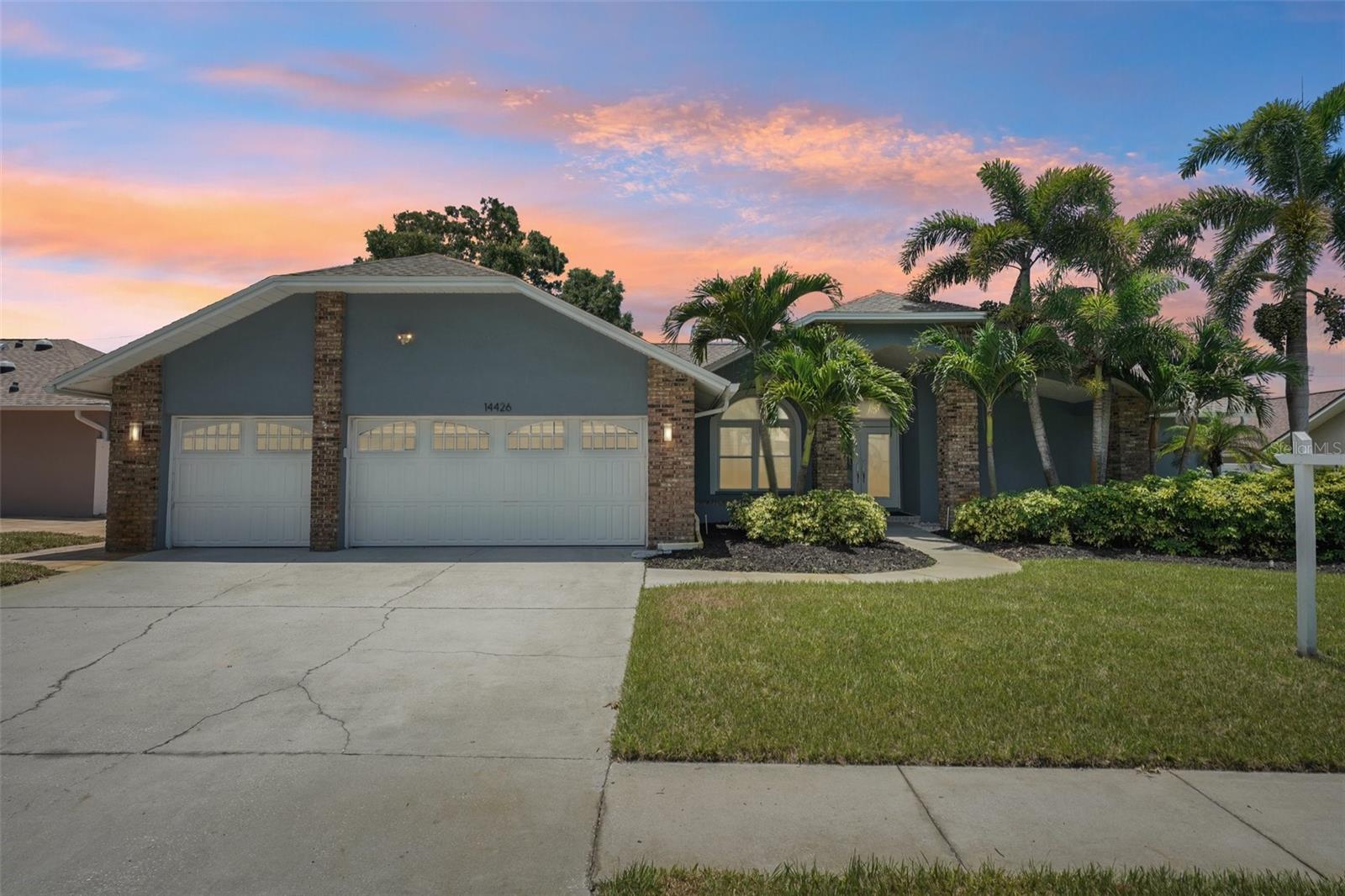 Welcome to refined comfort in the highly desirable Collins Estates. Nestled in a peaceful neighborhood just minutes from the sparkling Gulf beaches, this exceptional residence offers the perfect balance of luxurious living and a relaxed, family-friendly lifestyle. From the moment you enter, you are greeted by soaring vaulted ceilings, abundant natural light, and an inviting open layout. The spacious living room features sliding glass doors that seamlessly connect to the screened lanai and pool area. Designed for both everyday living and entertaining, the chef's kitchen showcases gleaming granite countertops, abundant cabinetry, a breakfast bar, stainless steel appliances, and additional space for casual dining. The adjacent family room features durable tile flooring and a cozy electric fireplace, creating a warm gathering space that flows effortlessly to the outdoor living area. Outside is your own private tropical retreat, complete with a screened-in pool and spa, where expansive sliding doors from both living areas invite seamless indoor-outdoor living under the Florida sunshine. A deep well irrigation system helps maintain the lush landscaping while providing an efficient and cost-effective water source. The primary suite serves as a private sanctuary with soaring ceilings, abundant natural light, beautiful wood flooring, and direct access to the lanai. It also features an oversized walk-in closet and a spa-inspired ensuite bath with dual vanities, a luxurious soaking tub, and a separate walk-in shower. Two additional bedrooms share a full bath, while the fourth bedroom offers a private entrance and full bath, making it ideal for guests, multigenerational living, or an in-law suite. Additional highlights include a brand-new water heater, a three-car air-conditioned garage, a Samsung all-in-one washer/dryer, and a prime location close to the area's finest shopping, dining, schools, and Gulf beaches. Located outside of a flood zone, this remarkable home offers peace of mind and an exceptional opportunity to experience the very best of Florida's coastal lifestyle.