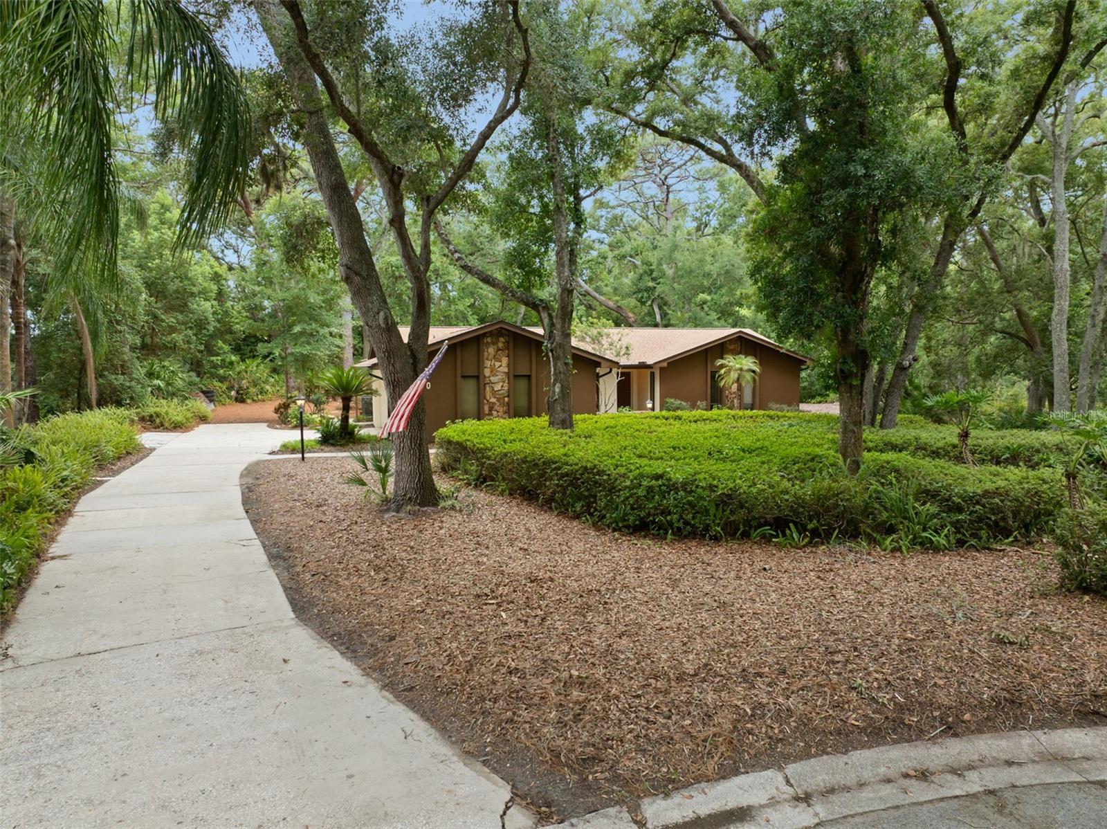 A Rare Hidden Gem in the Heart of Dunedin!

Welcome to 1660 Narnia Court, where the tranquility of nature meets the convenience of one of Pinellas County’s most sought-after communities. Tucked away on a peaceful 0.64-acre cul-de-sac lot, this one-of-a-kind property offers the feeling of your own private retreat while being just golf cart distance to vibrant Downtown Dunedin.

Surrounded by majestic trees and lush greenery, this exceptional home is perfectly positioned adjacent to city-owned nature preserve land and behind the Toronto Blue Jays’ practice facility creating a setting that is both peaceful and incredibly private.

Offering over 2,444 heated square feet and 3,669 total square feet this beautifully maintained home features 4 spacious bedrooms, 2.5 bathrooms, multiple living spaces including a separate family room and formal dining room, and a large screened lanai that seamlessly blends indoor and outdoor living.

The beautifully updated kitchen is the heart of the home, featuring rich wood cabinetry, granite countertops, ample workspace, and generous storage, making it ideal for everyday living and entertaining alike. Additional updates include a new roof (2022) and A/C units (2019),, Water Heater is 2023 and new gutters, soffit(2022) with leaf filter guards added in 2023 providing added value and peace of mind.

Step outside and imagine the possibilities. The expansive backyard offers endless room to create your dream outdoor oasis, whether that’s a resort-style pool, flourishing gardens, play space, or an incredible entertaining area. Opportunities like this are becoming increasingly rare in Dunedin.

An oversized two-car garage and an extra-wide driveway provide abundant parking for vehicles, golf carts, boats, or recreational toys.

If you’ve been searching for a property that offers the serenity of nature without sacrificing convenience, this is the one. Experience the magic of peaceful living just minutes from the waterfront, award-winning restaurants, charming shops, breweries, parks, and everything that makes Downtown Dunedin one of Florida’s most beloved destinations.

Properties offering this combination of privacy, land, location, and lifestyle rarely come to market. Don’t miss your opportunity to make this extraordinary Dunedin retreat your own.