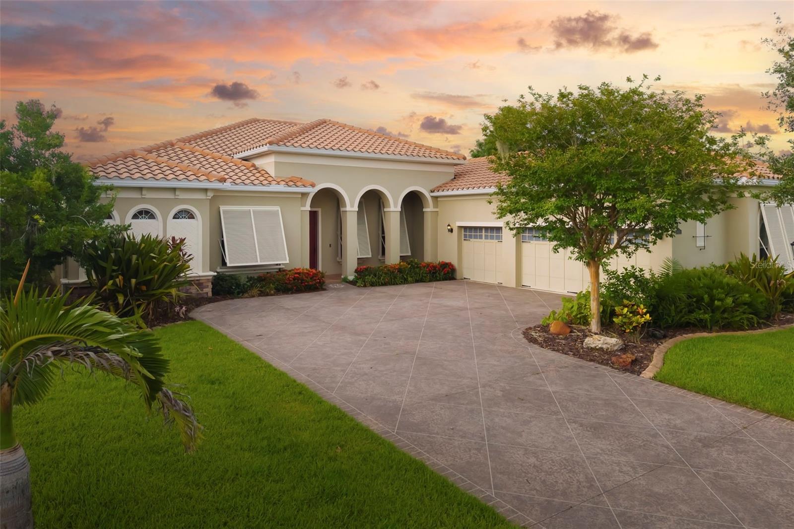 Nestled within the exclusive enclave of Regent Lake, an intimate community of just 13 residences, this exceptional lakefront estate offers a rare opportunity to enjoy refined living on more than an acre overlooking a picturesque spring fed lake. Showcasing the sought after Osprey floor plan, this thoughtfully designed four bedroom, three bathroom residence spans more than 3,100 square feet and includes a private office, an oversized three car garage, and a split floor plan that balances elegant entertaining with everyday comfort.

A long approach welcomes you to a setting defined by privacy, tranquility, and sweeping water views. Inside, the spacious living areas are thoughtfully designed to capture the beauty of the surrounding landscape while providing an inviting flow for both everyday living and entertaining. The gourmet kitchen is the heart of the home, featuring granite countertops, custom wood cabinetry, stainless steel appliances, a built in oven and microwave, cooktop, walk in pantry, center island, breakfast bar, and a charming morning room overlooking the grounds.

The primary suite serves as a peaceful retreat with direct access to the lanai and pool, serene lake views, dual closets, dual vanities, a soaking tub, and a separate walk in shower.

Designed to embrace Florida's indoor outdoor lifestyle, the screened lanai and sparkling pool provide the perfect backdrop for entertaining or quiet evenings watching spectacular sunsets over the water. The expansive homesite offers a private fenced area for pets and abundant opportunities to enjoy the natural beauty and wildlife surrounding the lake.

Thoughtful improvements include a new air conditioner and water heater in 2025, Bahama hurricane shutters, a whole house generator with a buried 500 gallon propane tank, a reinforced 150 mile per hour rated garage door, added attic insulation, and beautiful new flooring throughout all bedrooms.

With low HOA fees, no CDD fees, and a location just minutes from shopping, dining, top rated schools, and Sarasota's world renowned beaches, this is more than a home. It is an opportunity to enjoy the privacy of an estate sized waterfront home with the convenience of city amenities nearby.