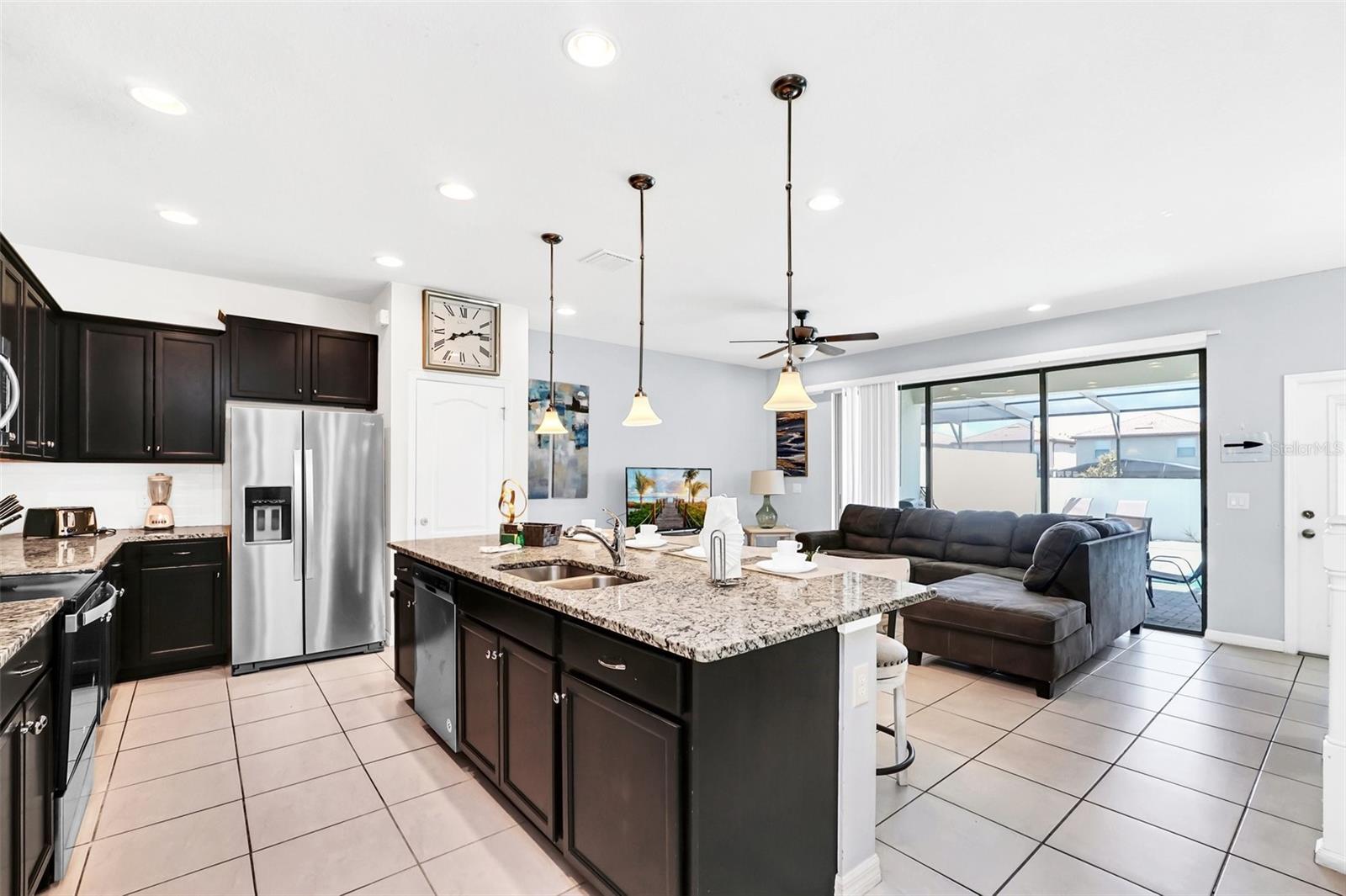 UNIQUE OPPORTUNITY AT WINDSOR AT WESTSIDE | PREMIUM CORNER LOT Step into luxury living with this stunning fully furnished 5 bed/4.5 bath pool home located in the highly sought-after, gated vacation community of Windsor at Westside, just minutes from Disney. With a spacious 2,265 SqFt open-concept floor plan, this home offers comfort, style, and functionality for your ideal vacation retreat or primary residence. Upon entering through the welcoming front porch, you'll be immediately struck by the natural light that fills the home, accentuating its beautiful design and layout. The expansive oversized lanai and pool deck provide the perfect space for outdoor relaxation, complete with a large, heated pool, screen enclosure, and attractive brick pavers. A master bedroom on the main floor offers extra privacy and convenience, perfect for families or guests. The kitchen is a chef's dream, outfitted with top-of-the-line stainless steel appliances, including a refrigerator with an ice maker, glass cooktop range, microwave, and dishwasher. The gray granite countertops and extended island with double sinks for ample space for cooking and entertaining, while the open layout connects seamlessly to the dining and living areas, with views of the pool through sliding glass doors. On the Second Floor, there is a spacious loft/game room that offers additional space for entertainment, surrounded by four generously sized bedrooms. The master bedroom is with a walk-in closet and a luxurious bathroom with double vanities, granite counters, and a glass-enclosed shower. Your family will love the specially themed Disney and ocean-style bedrooms, designed to spark their imagination. More importantly, the owner just replaced the brand-new recycled and composite flooring for the whole second floor. Located just minutes from Orlando’s world-renowned theme parks, Windsor at Westside offers a wide range of resort-style amenities: On-site restaurant & coffee bar, Zero-entry pool with a poolside bar, Fitness center, Basketball, soccer, and volleyball courts, Gaming stations, Playground, splash pad, and waterslides. Don’t miss out on this rare opportunity to own a premium corner-lot pool home in a community that has it all. Whether you’re looking for a personal oasis or an investment in vacation property, this home is the perfect blend of luxury and convenience. Schedule your private tour today and make this stunning home your own!