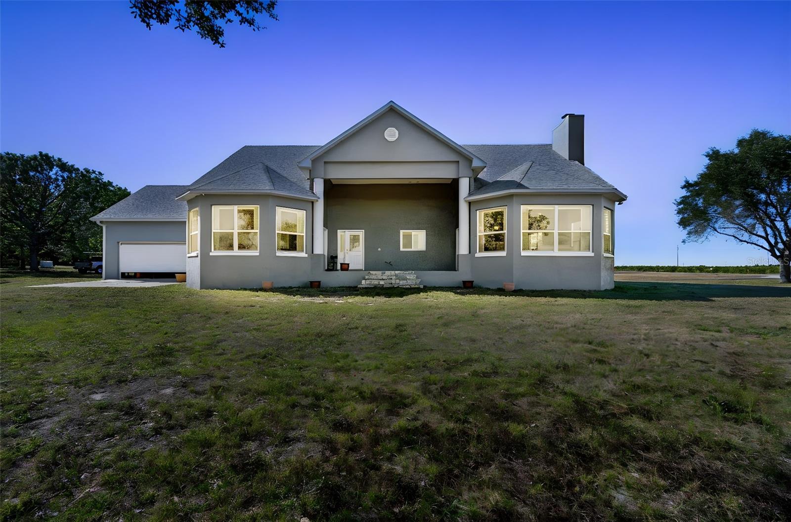 Experience the rare opportunity to own 5.68 acres of private, open land in Lake Alfred, just minutes from Florida Polytechnic University and Lakeland Linder International Airport. With access to Lake Griffin and a convenient drive to Disney, Orlando’s world-famous attractions, and Tampa Bay’s beaches, this property offers the perfect blend of peaceful country living and Central Florida convenience.

Enjoy wide-open space with endless potential for outdoor hobbies, recreational vehicles, future expansion, or creating your dream outdoor oasis. Take in the scenic surroundings, embrace the privacy that only acreage can provide, and enjoy lake access for boating, fishing, or simply relaxing by the water. The location also offers easy access to top-rated schools in Lakeland and Winter Haven.

The move-in-ready home features major updates already completed, including a brand-new water heater in December 2025, new AC in December 2024, and a roof replaced in March 2018 for added peace of mind. Inside, a versatile flex room above the garage provides endless possibilities for multigenerational living, a guest suite, home office, or bonus room. The reinforced laundry room also serves as a storm room, offering an extra layer of safety during Florida weather.

With easy access to Disney, Orlando, major highways, and Florida’s beautiful beaches, this property truly strikes the ideal balance between seclusion and accessibility.