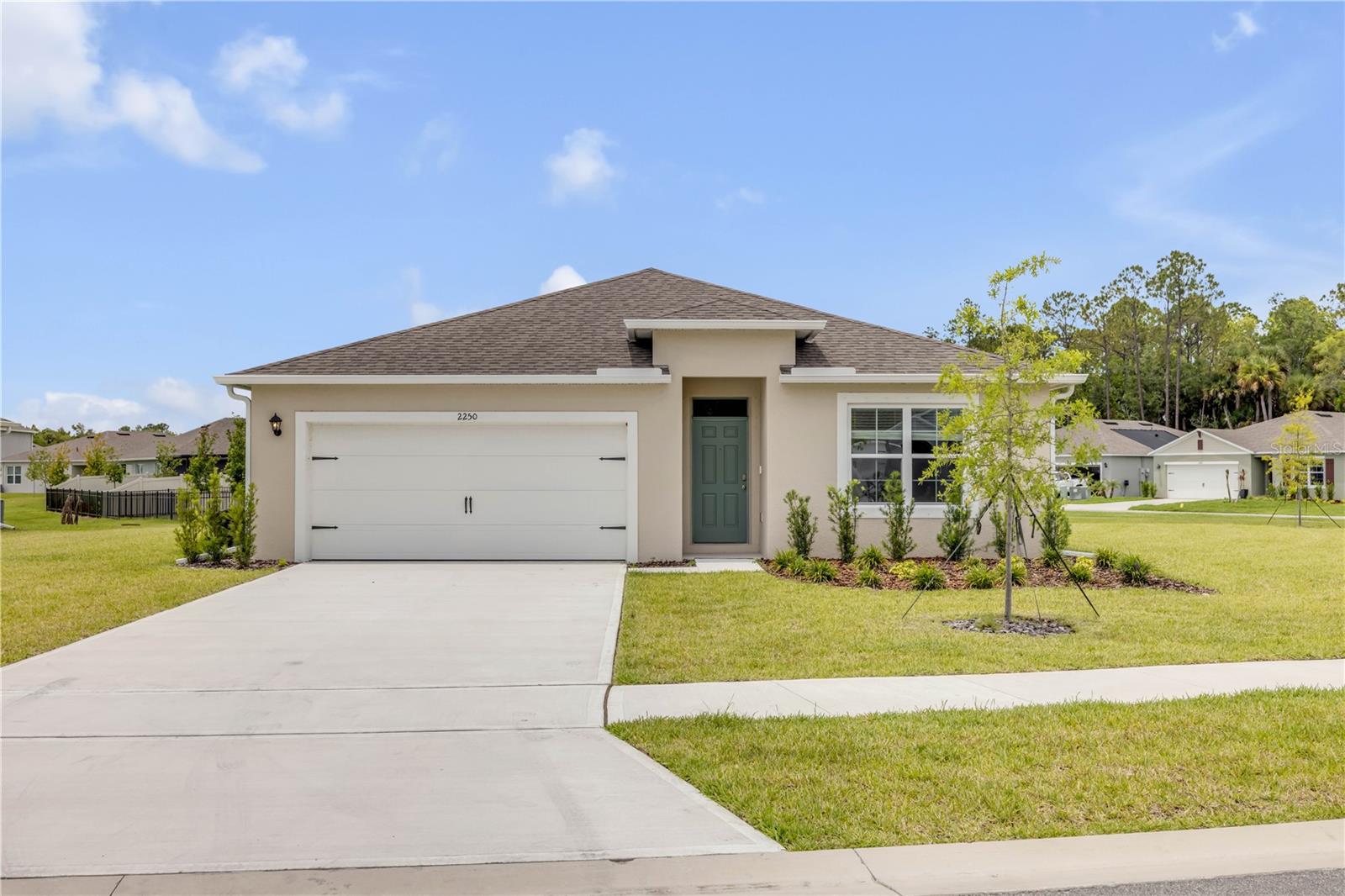 Experience the appeal of new construction without the wait in this beautifully designed 2025 home located in the desirable Oak Leaf Preserve community. Built with durable all-concrete block construction, this thoughtfully designed one-story floor plan offers an open-concept layout that seamlessly connects the kitchen, dining area, living room, and covered lanai—creating an ideal space for both entertaining and everyday living.

The spacious kitchen serves as the heart of the home, featuring stainless steel appliances, abundant cabinetry, a generous pantry, and a large island overlooking the main living areas. All appliances convey, adding immediate convenience and value.

The private owner's suite is tucked away at the rear of the home and offers a walk-in closet along with an en-suite bath complete with dual vanities and a walk-in shower. Two additional bedrooms and a full guest bath provide comfortable accommodations for family, guests, or a home office. A dedicated laundry room with privacy doors adds convenience and functionality.

Additional upgrades include window coverings throughout and newly installed gutters, enhancing both comfort and exterior protection. Like all homes in Oak Leaf Preserve, this residence includes Smart Home technology, allowing you to control key features of your home from your smart device whether you're at home or away.

Enjoy the peace of mind that comes with a nearly new home while taking advantage of the convenience and amenities of Oak Leaf Preserve. Buyer and buyer's agent are responsible for independently verifying all HOA information, fees, leasing restrictions, and community regulations.