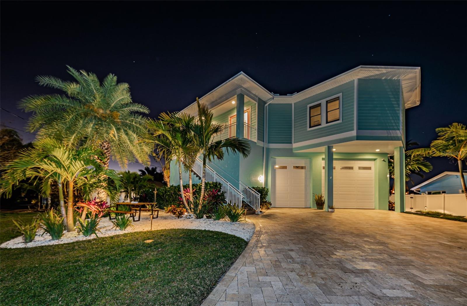 A GORGEOUS AND WELL-CONSTRUCTED COASTAL CONTEMPORARY RESIDENCE RESTS HIGH ABOVE THE WATERFRONT – THE ULTIMATE PEACE-OF-MIND!  Lush landscaping and a pleasing brick paver driveway introduce a remarkable home with an extensive list of exciting features and amenities.  Driftwood-style flooring, rich woodworking and 10ft+ ceilings deliver an elegant, alluring feel.  Appealing entry foyer introduces a splendid open great room that overlooks the waterfront.  Large living area transitions to lovely casual waterfront dining & seating areas.  Step out to the 36ft wide balcony (220sqft under cover) and take in wonderful views of the waterfront & pool deck.  The fabulous chef’s kitchen boasts terrific granite surfaces, attractive shaker-style & beaded-board coastal cabinetry, gas cooking, and a grand island bar with farmhouse sink & generous storage.  Owner’s suite is impressive!  Overlooking the waterfront and opening to the balcony, you’ll appreciate it large sitting areas and spacious walk-in closet system.  The owner’s bath is a lavish, pampering experience, with graceful dual vanities, large modern jetted spa tub beautifully encased in elaborate tilework, and a private walk-in zero-entry rain shower with stunning tilework.  Bedrooms 2 & 3 enjoy waterviews and are supported by an oversized guest bath and its dazzling walk-in rainshower.  Your lower level is huge and built for a motor coach with 12-ft garage doors, 30 AMP service and water/sewer hook-ups. Area provides extensive storage and tremendous multi-purpose usage options. Out back, discover the definitions of coastal oasis. A superb shellstone paver deck supports a 250sqft custom built-in cooking center with huge bar area – luxuriously finished in granite/stone, with fine wood ceilings and SS gas cooking.  You’ll love the pool and its Miami-like Hyydrazzo surfaces, fountain and hot tub.  Pool is both heated & cooled, with saltwater conversion system - and is supported by a private hot/cold water outdoor shower. Matching built-in gas firepit is the perfect place for evening conversation.  Updated seawall supports a 16K lb boat lift & private boatslip for 45ft cruiser (dual 30amp shore power circuits).  Tankless hotwater heating, whole-house gas generator, extensive low voltage lighting, water softening/filtration + reverse osmosis and so much more. A short walk to the soft sands of Redington Beach, or easy boat ride to the Gulf.  A fantastic value in a great location!  Buyer to confirm all dimensions.