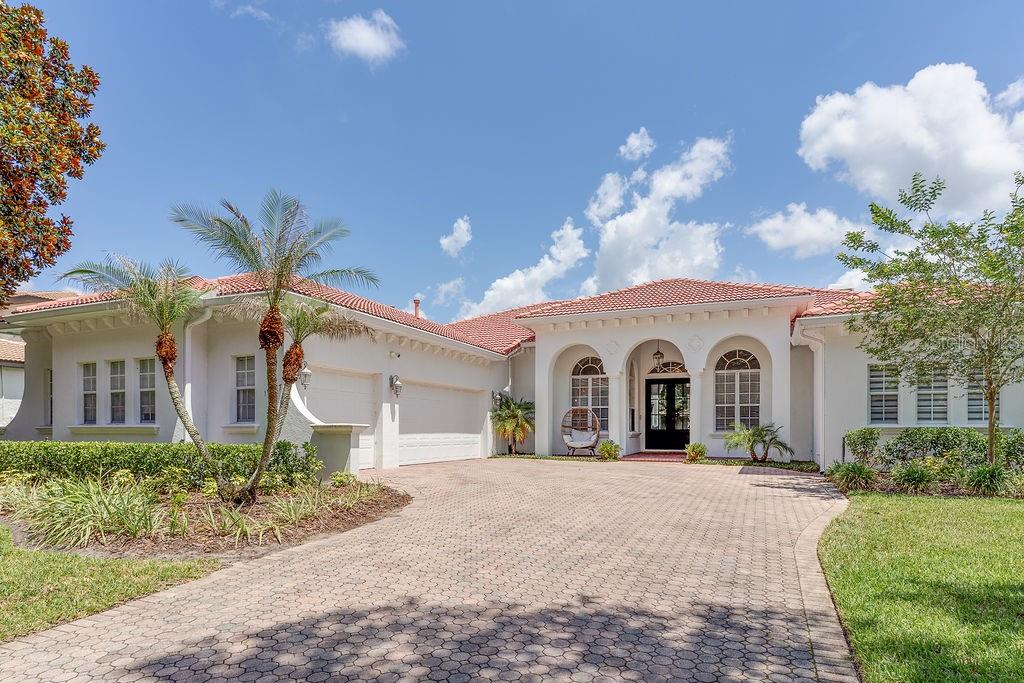 Welcome to 11027 Hawkshead Court, a beautifully updated 4-bedroom plus a dedicated office, 3 full bath, and 1 half bath residence offering approximately 3,500 square feet of living space on a private 0.37-acre corner lot in the guard-gated Reserve at Lake Butler Sound, in the heart of Windermere, complete with 24 hour roving security. 

With extensive renovations completed between 2022 and 2026, this move-in-ready home combines luxury finishes, timeless design and excellent craftsmanship throughout.

The heart of the home is an open-concept kitchen featuring upgraded countertops, a 7-foot built-in Dacor refrigerator with dual ice makers, a 5-burner Dacor gas cooktop, and double wall ovens equipped with advanced features including steam cooking and flexible oven configurations. Cohesive flooring throughout the home creates a seamless flow from room to room.

The home features stunning custom built-ins in the living room complete with a rolling library ladder, as well as a striking custom entertainment wall with fireplace and built-in lighting. Soaring 12-foot ceilings in the main living areas and primary suite create an airy, elegant atmosphere.

The thoughtfully designed split floor plan offers exceptional privacy, with the primary suite situated on the opposite side of the home from the secondary bedrooms. A dedicated office with custom built-in shelving provides an ideal work-from-home space. The luxurious primary retreat features dual custom closets and a spa-inspired bathroom complete with marble tile, a custom vanity, and a freestanding soaking tub.  Custom California Closet systems extend throughout the home, maximizing organization and functionality.

Two secondary bedrooms are connected by a Jack-and-Jill bathroom, while the fourth bedroom enjoys access to its own full bath, making it ideal for guests, teens, or multigenerational living.

Step outside to your private backyard oasis. The gas heated pool and raised spa are surrounded by multiple gathering spaces, including shaded seating and dining areas perfect for relaxing or entertaining. The fully fenced backyard offers exceptional privacy and features both a turfed side yard with putting green and a separate grassy side yard. Set on a private 0.37-acre corner lot bordered by two quiet dead-end roads, the outdoor living spaces feel both peaceful and secluded.

Additional improvements include exterior and interior painting, premium Pella doors, a whole-home owned water softener system, new flooring throughout, a new septic drain field, and much more.

Located within one of Windermere's most sought-after luxury communities, this home offers privacy, functionality, and refined living. Lovingly maintained and extensively improved, this property provides the opportunity to enjoy resort-style living without the hassle of future renovations - simply move in and enjoy.