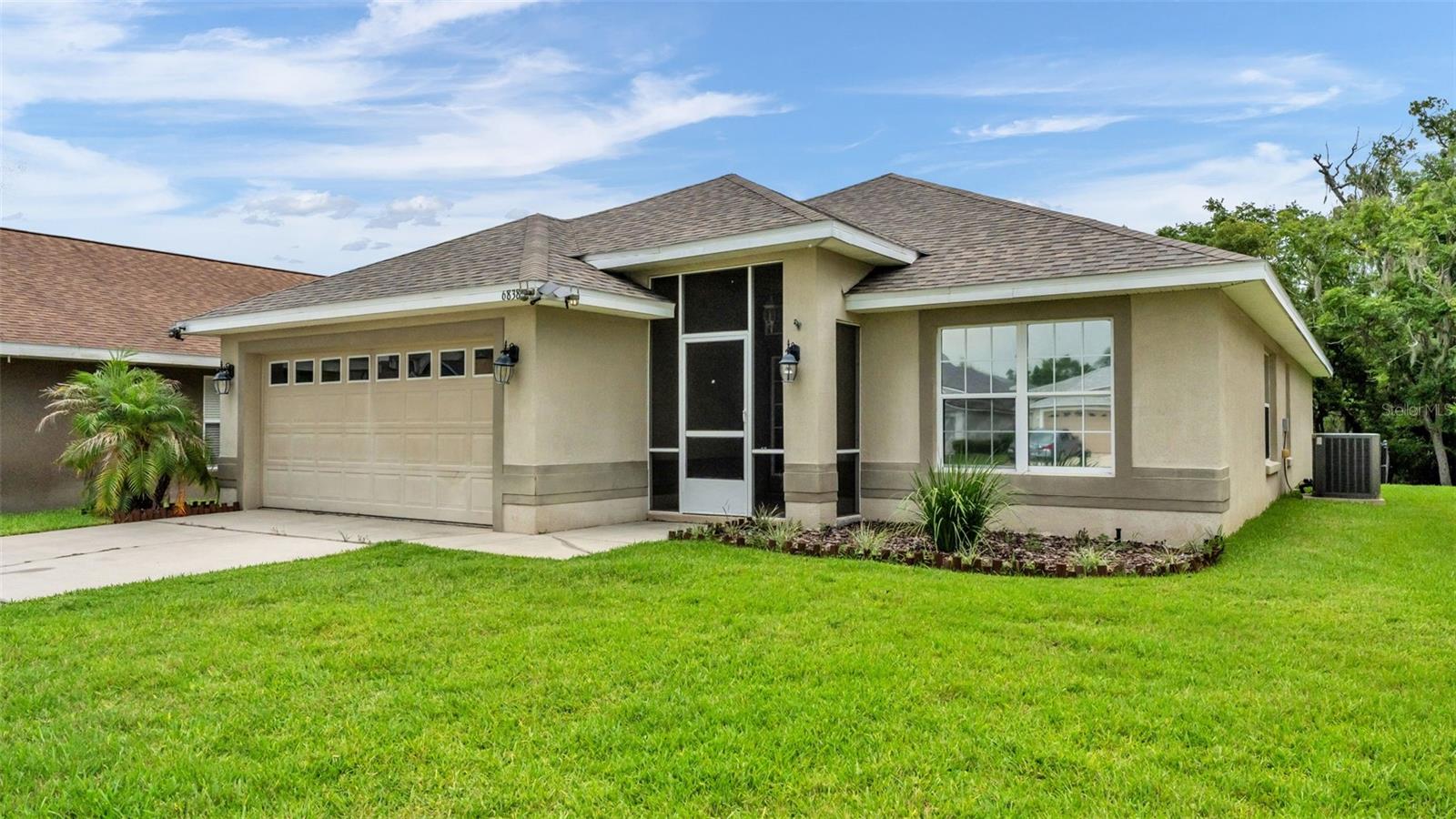 Gated, lakefront, private dock, community pool, this is South Lakeland, Florida living at its finest. Welcome to this beautifully maintained 4-bedroom, 2-bath home featuring a desirable triple-split floor plan and a bonus Florida room, the perfect place to enjoy your morning coffee while watching the sunrise over the lake. Twin Lakes at Christina offers a clubhouse, community pool, lawn maintenance, and exterior pest control, making everyday living as convenient as it is enjoyable. Step outside to your private dock with electricity and spend your days boating, fishing, or simply relaxing while taking in the peaceful waterfront views. Inside, the thoughtfully updated interior features a custom kitchen with wood cabinetry, granite countertops, a matching granite backsplash, new sink, and updated fixtures. The spacious primary suite offers a stunning all-granite walk-in shower and double vanity with granite countertops, while the guest bath has been beautifully updated with coordinating granite finishes. New luxury vinyl plank flooring, fresh interior paint, and custom granite window sills add elegant finishing touches throughout the home. Major updates include the kitchen and bathrooms remodeled 2025, a 2022 roof, 2022 garage door motor, 2023 irrigation system, 50-gallon water heater, new landscaping, and more, giving you peace of mind for years to come. This one is truly move in ready just waiting for you!