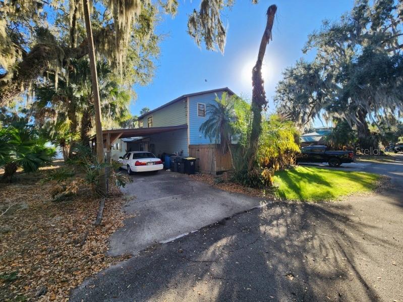 9428 Cat Track Trail is located on a unique inlet of Lake Walk-in-Water in Central Florida.  Walk-in-Water Lake is the largest lake in Polk County and has long been recognized as the premier bass fishing lake in Central Florida.  The Unique inlet shields the dock from typical winds prominent in Florida most of the year. Great fishing and boating activities abound on this lake.  This property has the largest dock under roof on the lake.  Featuring a 37 ft. x 53 ft. or 1,950 sq. ft. dock under roof and an 8 ft. x 21 ft. fishing pier. The dock has water and electricity plus a 250 gallon live shiner holding tank, two large boat slips with electric boat lifts, partial kitchen with granite top island including sink. This house is a split level with two large family/game rooms, 4 full baths and easily sleeps 12 or more people.  3 Bedrooms and several other beds are located in unique areas throughout the upstairs area.  3 complete kitchens and plenty of room for family and guests.  Metal roof, washer/dryer and fridge to remain, with a garage and carport.  Well water Irrigation system and complete automatic water filtration system provides excellent drinking water. This is a sportsman's paradise and weekend or second home dream.  Many areas have been remodeled or rebuilt.  Seller motivated due to family illness.