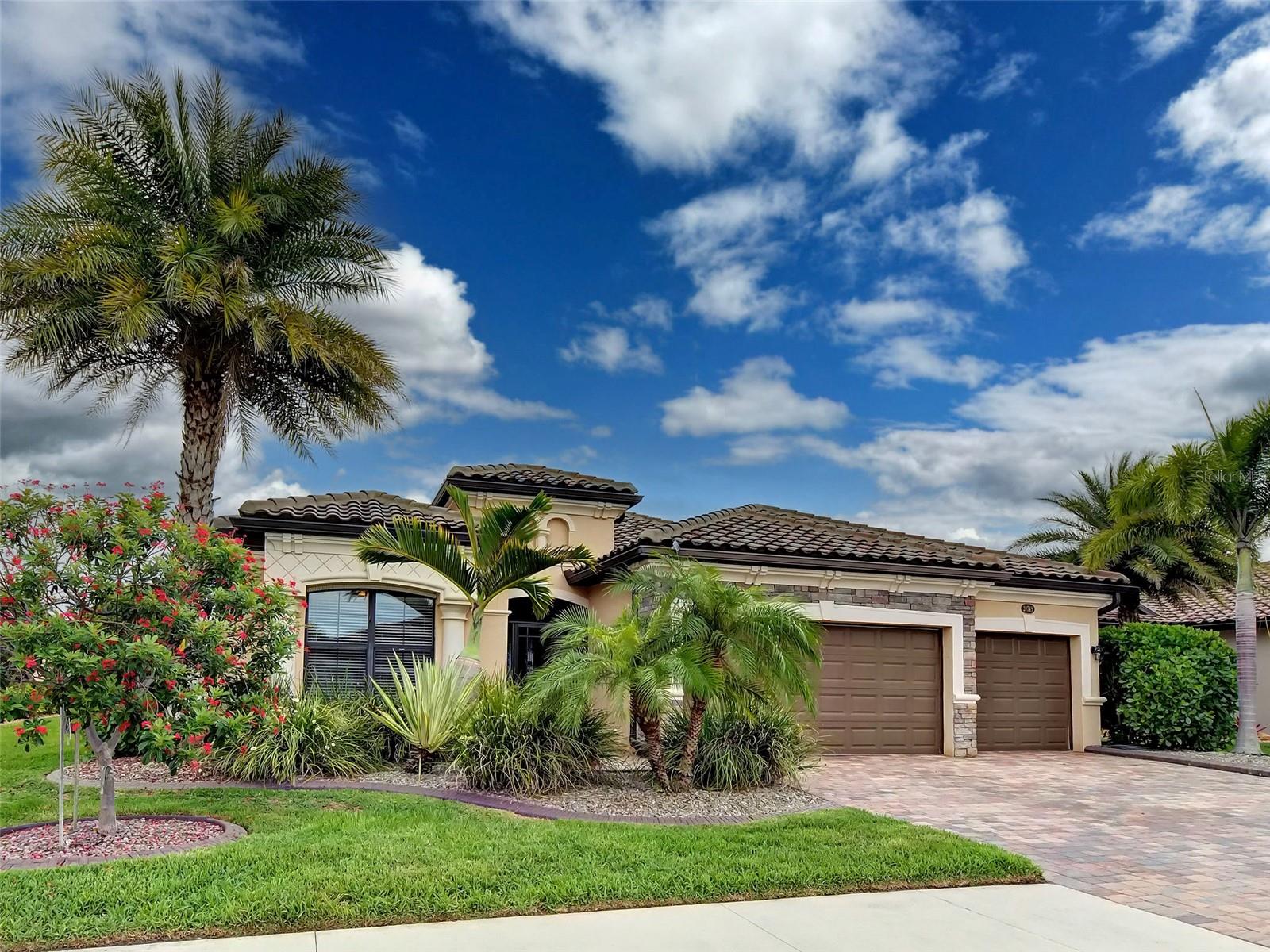 Welcome to this exquisitely maintained and beautifully upgraded Princeton model offering 2,243 square feet of thoughtfully designed living space, 4 bedrooms, 2 bathrooms, and a spacious 3-car garage. From the moment you arrive, you'll appreciate the pride of ownership evident throughout, beginning with the screened front entry, attractive concrete curbing, and professionally landscaped exterior.

As we step inside, notice the elegant dining room featuring a stunning full-wall mirror that enhances both natural light and the sense of space. The home immediately showcases its attention to detail with plantation shutters throughout, contemporary finishes, and beautiful new herringbone-pattern luxury vinyl flooring that flows seamlessly through the primary suite.

The heart of the home is the expansive great room, highlighted by a coffered tray ceiling and abundant natural light. This inviting space opens effortlessly to the kitchen, where you'll find crisp  cabinetry with modern hardware, under-cabinet lighting, gleaming  quartz countertops, a large island perfect for entertaining, sliding pantry shelving, a newer garbage disposal, and a brand-new 5-burner range and oven.

The primary suite serves as a peaceful retreat, featuring a tray ceiling, custom-designed closets, and a luxurious en-suite bathroom complete with dual quartz vanities, a relaxing soaking tub, and a spacious step-down shower.

Guests will enjoy their own private accommodations in the well-appointed guest bath, which features a step-down shower, sliding glass doors, and a beautiful  quartz vanity. Ceiling fans throughout the home—including the lanai and garage—provide year-round comfort and efficiency.

One of the home's most desirable features awaits outside. The rear-facing southern exposure allows for abundant natural light while overlooking a serene water view. The fenced backyard creates a private oasis where you can relax or entertain on the covered lanai, protected by Storm Smart hurricane shutters and a Kevlar hurricane screen for added peace of mind.

Additional upgrades include a whole-house water filtration system and a 3-car garage equipped with its own mini-split air conditioning system, making it ideal for hobbies, projects, fitness equipment, or climate-controlled storage.

Located just moments from the community clubhouse and resort-style amenities, residents enjoy access to a sparkling pool, fitness center, steam room, craft and game rooms, pickleball courts, tennis courts, and basketball courts.

This exceptional home combines luxury, functionality, and an outstanding location, offering the perfect Florida lifestyle you've been dreaming of.