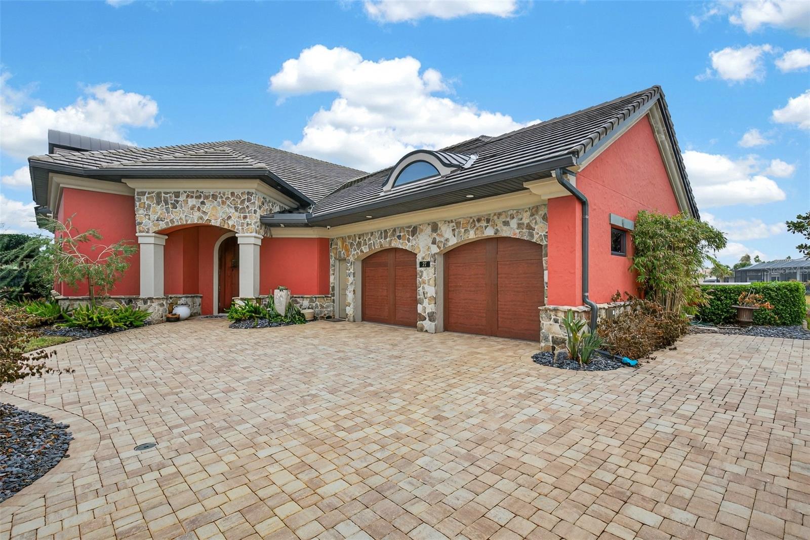 Welcome to your DREAM HOME in the beautiful gated premier Ocean Hammock community. This custom crafted exquisite beachside residence captures sweeping PANORAMIC LAKE AND GOLF COURSE VIEWS and is located privately on an oversized cul-de-sac lot – all within an easy walk to the BEACH. This home offers refined living with a resort style atmosphere. The expansive first floor living space showcases a grand open concept design, highlighted by a gas fireplace and walls of sliders that open to an impressive lanai featuring a pool and spa – creating a seamless indoor-outdoor experience. A spacious outdoor kitchen with alfresco dining area provides a stunning setting for entertaining. At the heart of the home, the CUSTOMED DESIGNED CHEF’S KITCHEN is appointed with premium stainless steel appliances and a statement Le Cornue range with six propane burners and dual electric ovens. The kitchen, with expansive casual dining area is complemented by a fully equipped butler‘s pantry with a second dishwasher, sink, refrigerator/ice maker, as well as a separate walk-in pantry, and a separate well appointed laundry room.The first floor also offers a primary bedroom retreat with a spa inspired bathroom, including soaking tub, dual vanities, oversized walk in shower, and a custom walk-in closet with built-in cabinetry.  On this floor there are also two separate en-suite guest bedrooms. A formal dining room adds timeless elegance for hosting intimate dinners or grand celebrations. The UPPER LEVEL offers 700 ft.² of versatile, living space, providing two additional rooms suitable for guest bedrooms, executive office, or media/game room, along with a full bath and a finished craft room. Completing this home is a dedicated workshop located off the garage, ideal for hobbies or additional storage. Enhancing energy efficiency and piece of mind, this home is equipped with solar panels and battery backup. This exceptional home reflects privacy, thoughtful design, and modern efficiency in a pristine setting.  As a resident of the Ocean Hammock HOA community you have access to the Ocean Walk complex, that includes clubhouse and pool where neighbors will gather for social activities. In addition, with a purchase of a Hammock Beach Club membership you can enjoy all the many amenities this club has to offer, including nine pools, eight hard tru tennis courts, four Pickleball courts, two world renowned golf courses, five restaurants, spa, and private beach services.