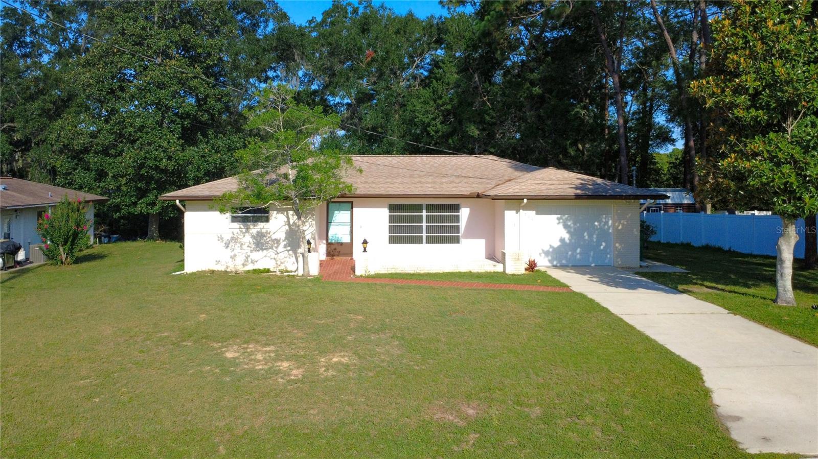 Welcome to this charming 2-bedroom, 2-bathroom ranch-style home ideally located just minutes from the heart of downtown Inverness. The open-concept living and dining area provides a welcoming space for everyday living and entertaining, with sliding glass doors leading to a spacious 21’ x 11’ Florida Room—perfect for year-round enjoyment. The well-appointed kitchen features granite countertops, bar seating, and seamless flow into an adjacent family room/flex space. Filled with natural light and offering its own access to the Florida Room, this versatile area can easily function as a family room, formal dining space, home office, or additional lounge. The primary suite offers a walk-in closet, with an en-suite bath complete with a tile shower and updated vanity.  The second full bathroom also has an updated vanity. Recent improvements include a new A/C system (2024), roof (2019), new garage door (2024), freshly painted garage, new flooring throughout most of the home, and updated ceiling fans. Additional features include a new storage shed and a newly added concrete slab—perfect for grilling or creating an outdoor entertaining area. Located in a highly desirable area, this home provides easy access to downtown Inverness amenities including lakefront parks, community festivals, the Market at the Depot, Valerie Theatre, dining, and boutique shopping. Schools, medical facilities, and the hospital are conveniently located approximately one mile away.