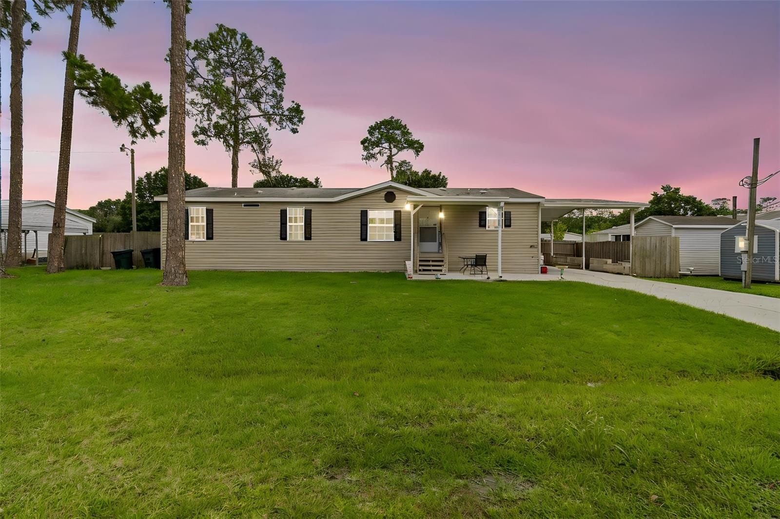 BEAUTIFUL 2018 DOUBLEWIDE MANUFACTURED Nobility HOME on OVER 1/3 ACRE on a quiet cul-de-sac in Auburndale. There is a CONCRETE DRIVEWAY that leads to COVERED PARKING as well as a COVERED PATIO to the front door. Upon entering the
home, you'll immediately notice the SPACIOUS LIVING ROOM with VAULTED CEILINGS. This is a true SPLIT PLAN where the large MASTER
BEDROOM includes an ENSUITE BATHROOM with DUAL SINKS, a STAND-UP SHOWER and GARDEN TUB. The KITCHEN has room for multiple chefs, with PLENTY of CABINETS and EXTRA COUNTER SPACE on the ISLAND that includes a BREAKFAST BAR. Imagine enjoying your morning coffee on the COVERED PORCH that has PRIVACY SCREENING, which allows you to enjoy the view of the HUGE, PRIVACY FENCED BACK YARD without allowing people to see inside during the day. Notice that there's plenty of room for playground equipment, a trampoline, or swimming pool. If you have a green thumb, this dark, rich soil provides the perfect foundation to create your dream flower or vegetable garden. There's space to store yard equipment in the ALUMINUM SHED. Best of all, there is NO HOA, and you're only 10 minutes to shopping and restaurants! This property is eligible for VA and FHA financing, so don't wait - call for a private showing today!