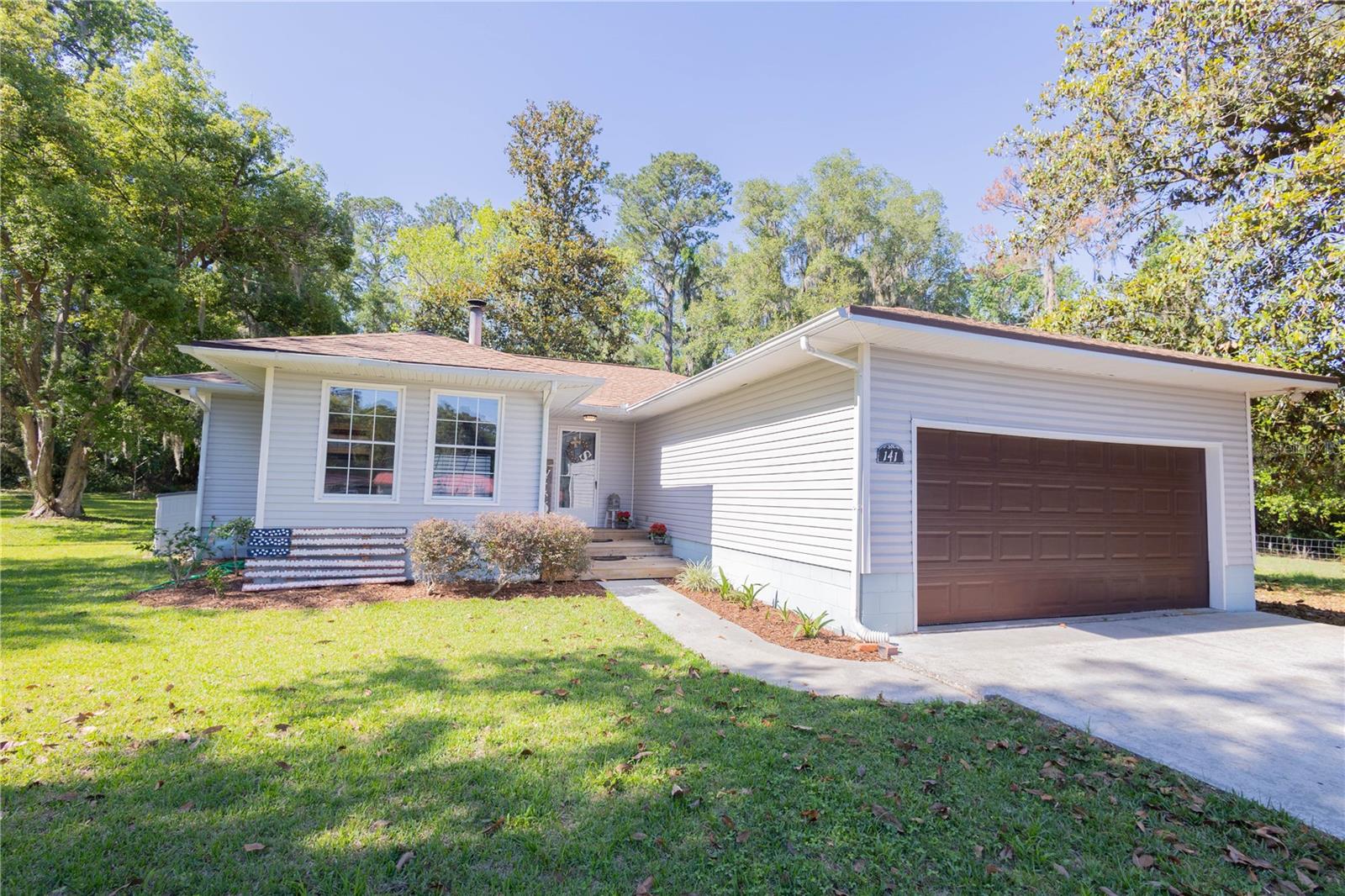 Country feel with city convenience! This move-in ready 3-bedroom, 2-bath home sits on a beautifully maintained nearly 1-acre lot in Lake City and offers the perfect blend of comfort, space, and natural beauty. Inside you’ll find spacious living areas, a functional kitchen with abundant cabinet storage and pantry space, and a relaxing primary suite complete with walk-in closets and a spa-style bath featuring dual vanities, a garden tub, and separate tiled shower.

The backyard is truly the highlight of this property — a peaceful setting filled with mature landscaping, including a stunning Magnolia tree and several large shade trees that create both beauty and privacy. With lake views visible from the kitchen window and throughout the backyard, this outdoor space offers endless potential to become your own private oasis. Whether you envision a pool, garden, entertaining area, or relaxing retreat, there’s plenty of room to make it your own. Additional features include a fenced backyard, circular driveway, and convenient access to shopping, dining, medical facilities, the VA, and major highways.