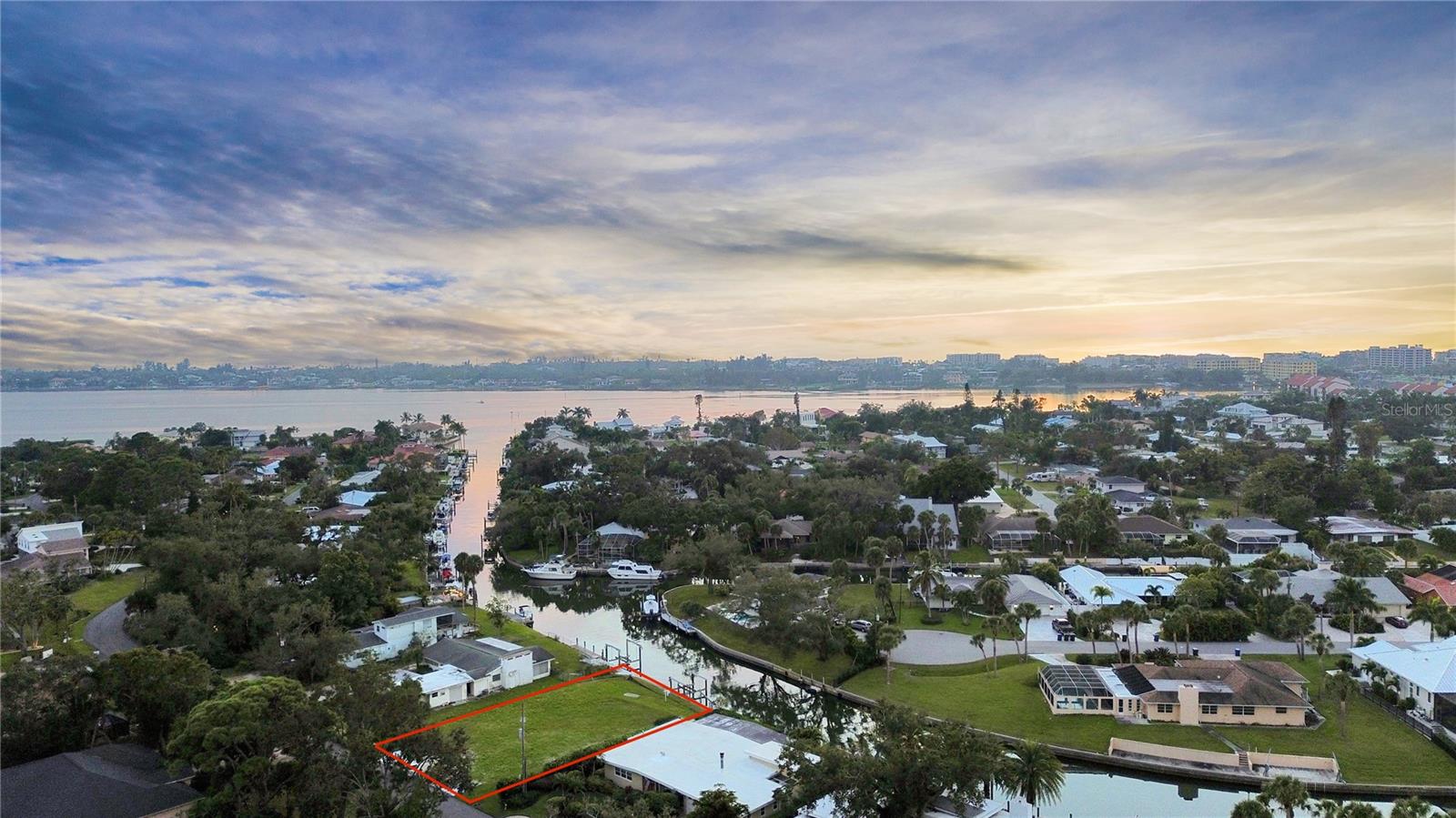 Welcome to 1849 Baywood Drive in Sarasota, Florida 34231 Situated on a .26-acre lot with an impressive 92-foot seawall, this cleared and ready-to-build property offers direct canal access to little Sarasota bay with no fixed bridges and just minutes from the Gulf of Mexico. The property is also walking distance to Siesta Key Beach, consistently ranked as America’s #1 beach, celebrated for its powdery white quartz sand and turquoise water. Whether you’re an avid boater, fisherman, or simply love being near the water, this property is your gateway to the quintessential Florida lifestyle. 

Imagine stepping out of your custom-built home and cruising through the open waters of Sarasota Bay in minutes, or exploring the turquoise waters near Midnight Pass, less than ten minutes away by boat. Living on a deep-water canal offers year-round enjoyment, from sunrise paddle boarding and kayaking to evening fishing and dolphin watching right from your own backyard. Local marine life includes snook, redfish, tarpon, mangrove snapper, and even gentle manatees that frequent these calm channels.

This highly desirable area of Sarasota has county-approved residential construction, saving you time and streamlining the path to building your custom coastal retreat. Custom builders in the area are well-versed in designing elevated, contemporary, and Key West–inspired homes to complement the waterfront setting—perfect for showcasing panoramic canal views and breathtaking sunsets.

Enjoy proximity to some of Sarasota’s finest amenities. Just 15 minutes to vibrant downtown Sarasota, residents can savor world-class dining, cultural attractions, and entertainment venues like The Van Wezel Performing Arts Hall, Marie Selby Botanical Gardens, and St. Armands Circle. 

From tranquil canal living to convenient access to Sarasota’s cultural and coastal attractions, 1849 Baywood Drive presents a rare opportunity to design your dream home and live the ultimate Gulf Coast lifestyle in one of Florida’s most prestigious waterfront neighborhoods.