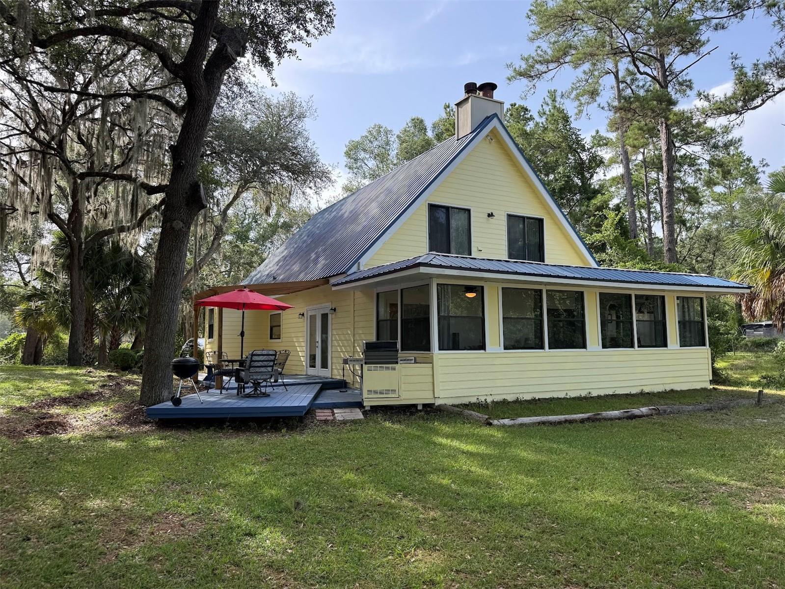 Exquisite Two-story Lake Front home nestled in the Ocala National Forest, close to a myriad of crystal-clear natural springs, like Juniper Springs, Alexander Springs, Salt Springs and more. Juniper Springs is only 14 minutes away. Property features a lakefront pier and dock with a lazy swing for Morning Sunrise Coffee or Evening Sunset Cocktails. Home features a chef’s kitchen with a large pantry, and an open floorplan for entertainment and relaxation. The enclosed porch opens up from the living room on both sides of the Fireplace with views of the Lake. Second floor master overlooking the Lake front has vaulted ceilings, skylight and fireplace. Fourth bedroom can be used for an in-home office. R-4 ZONING! POSSIBLE HOME-BASED BUSINESS OR LAKE FRONT VACATION RENTAL! Check out website for Juniper Springs!